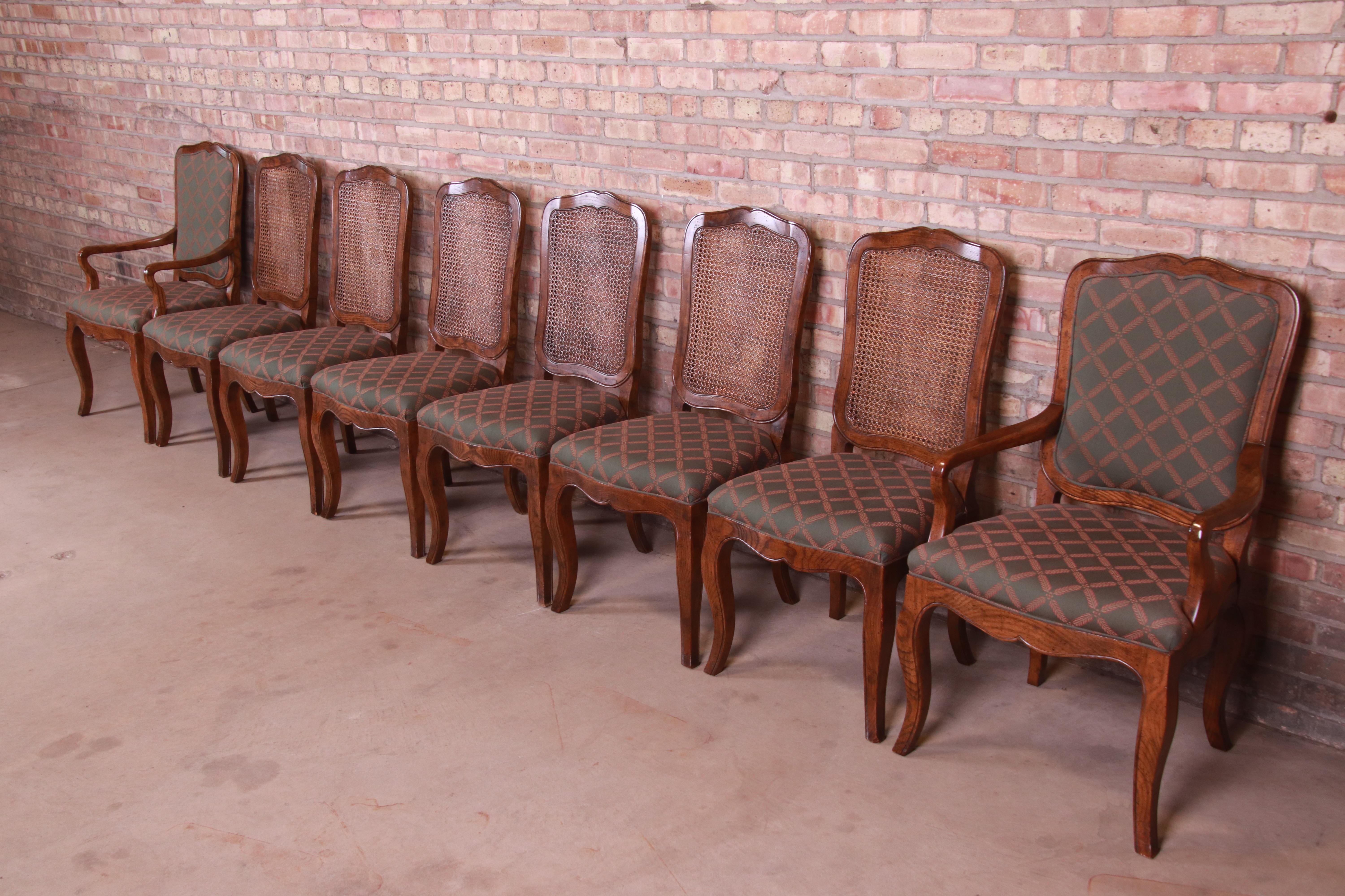 A gorgeous set of eight French Provincial Louis XV style dining chairs

By Baker Furniture

USA, Circa 1980s

Carved oak, with upholstered seats and caned backs.

Measures:
Side chairs - 19.63