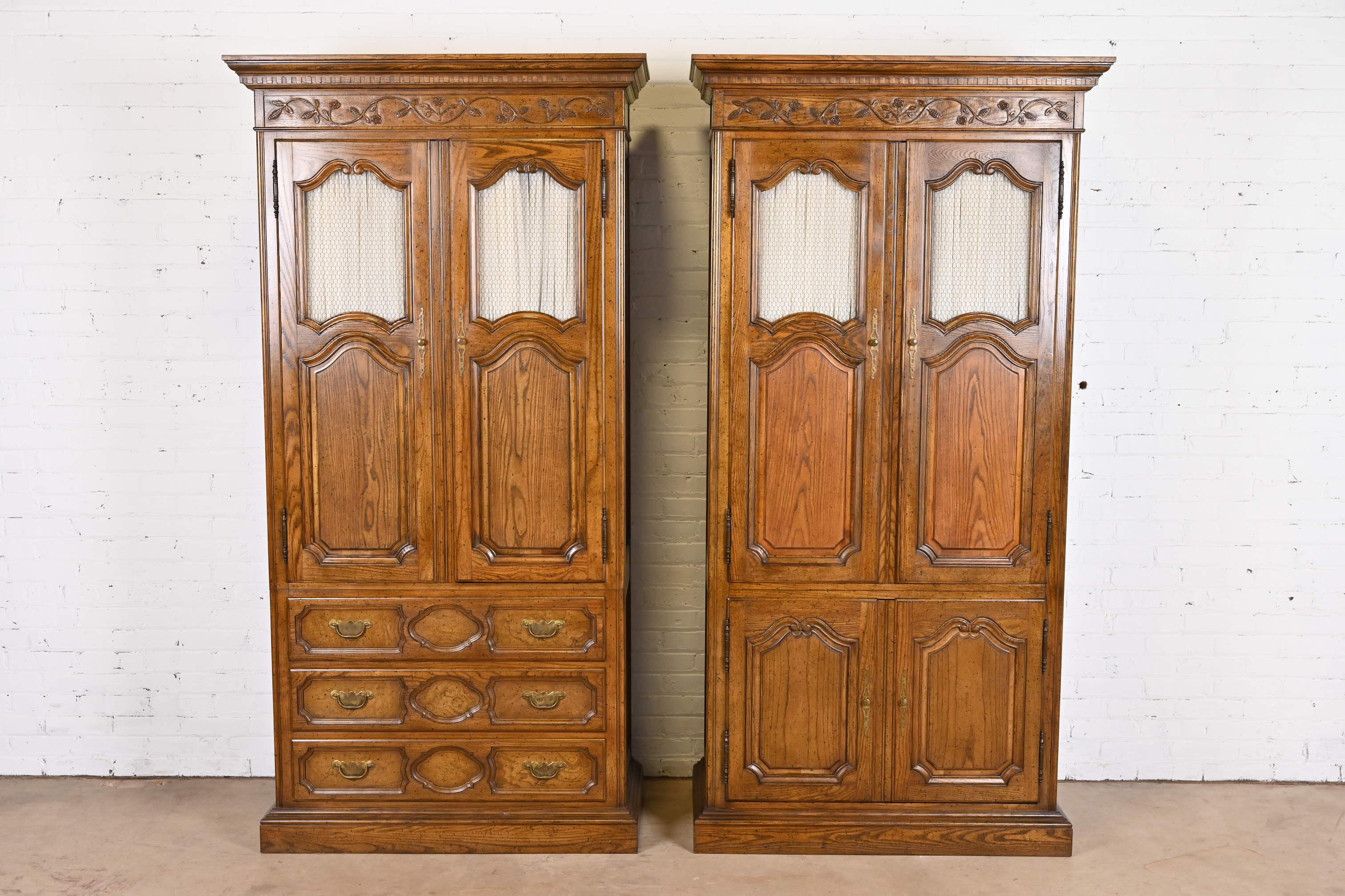 A gorgeous pair of French Provincial Louis XV style armoire dressers or linen presses

By Baker Furniture

USA, Circa 1960s

Carved oak, with original brass hardware.

Each measures: 42.75