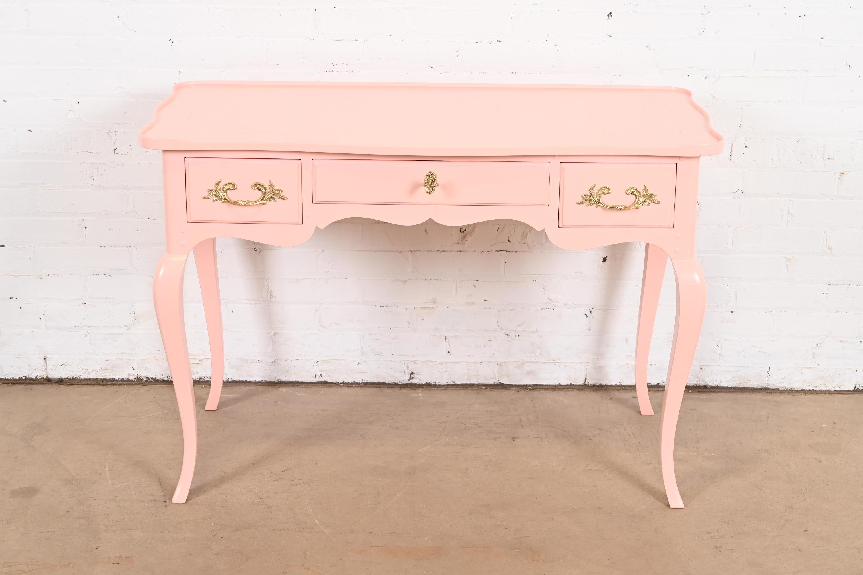 An exceptional French Provincial Louis XV style writing desk

By Baker Furniture

USA, Circa 1960s

Pink lacquered cherry wood, with original brass hardware. Drawer locks, and key is included.

Measures: 43.13