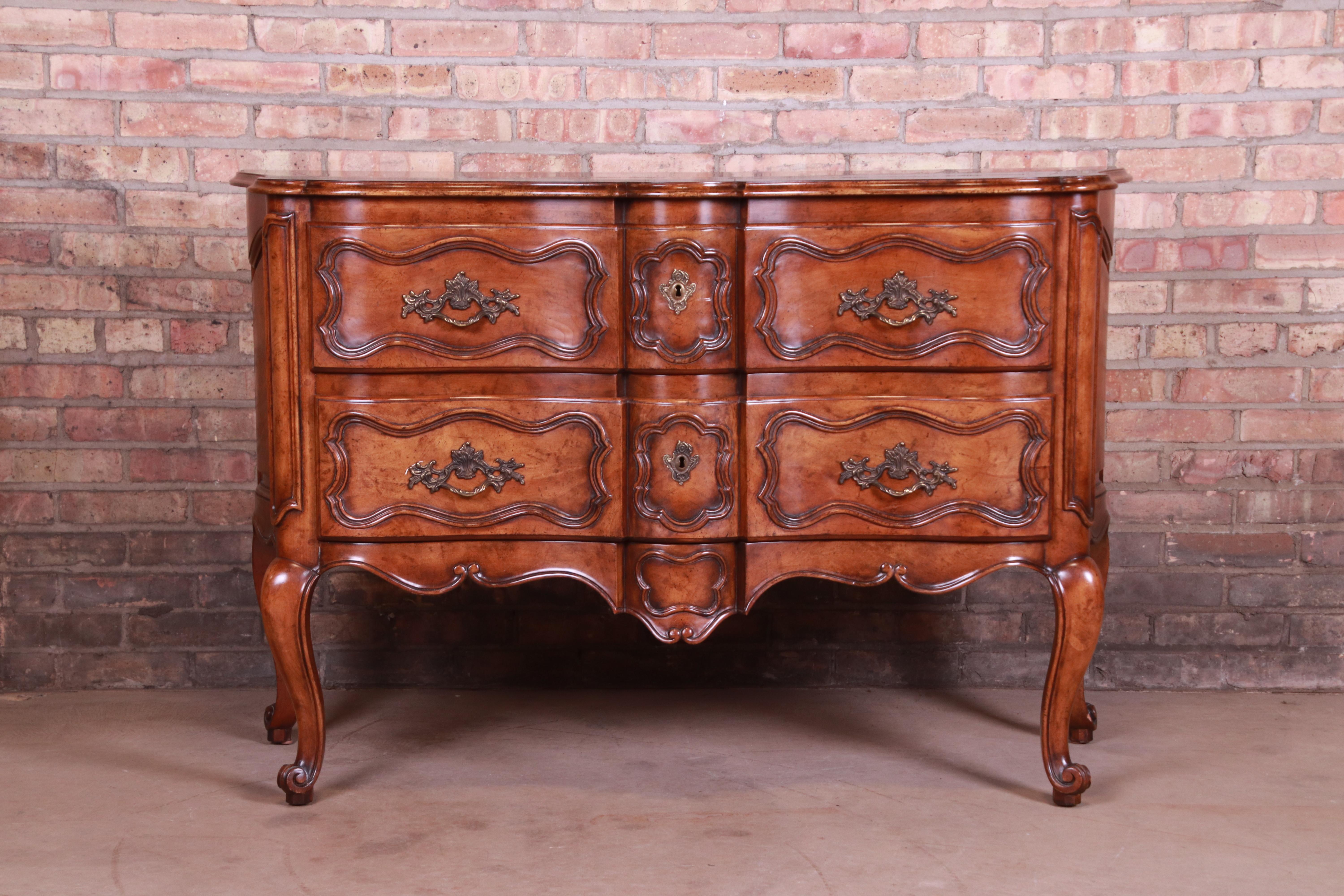 A gorgeous French Provincial Louis XV style chest of drawers, commode, or buffet server

By Baker Furniture

USA, circa 1980s

Carved walnut, with original brass hardware.

Measures: 52.25