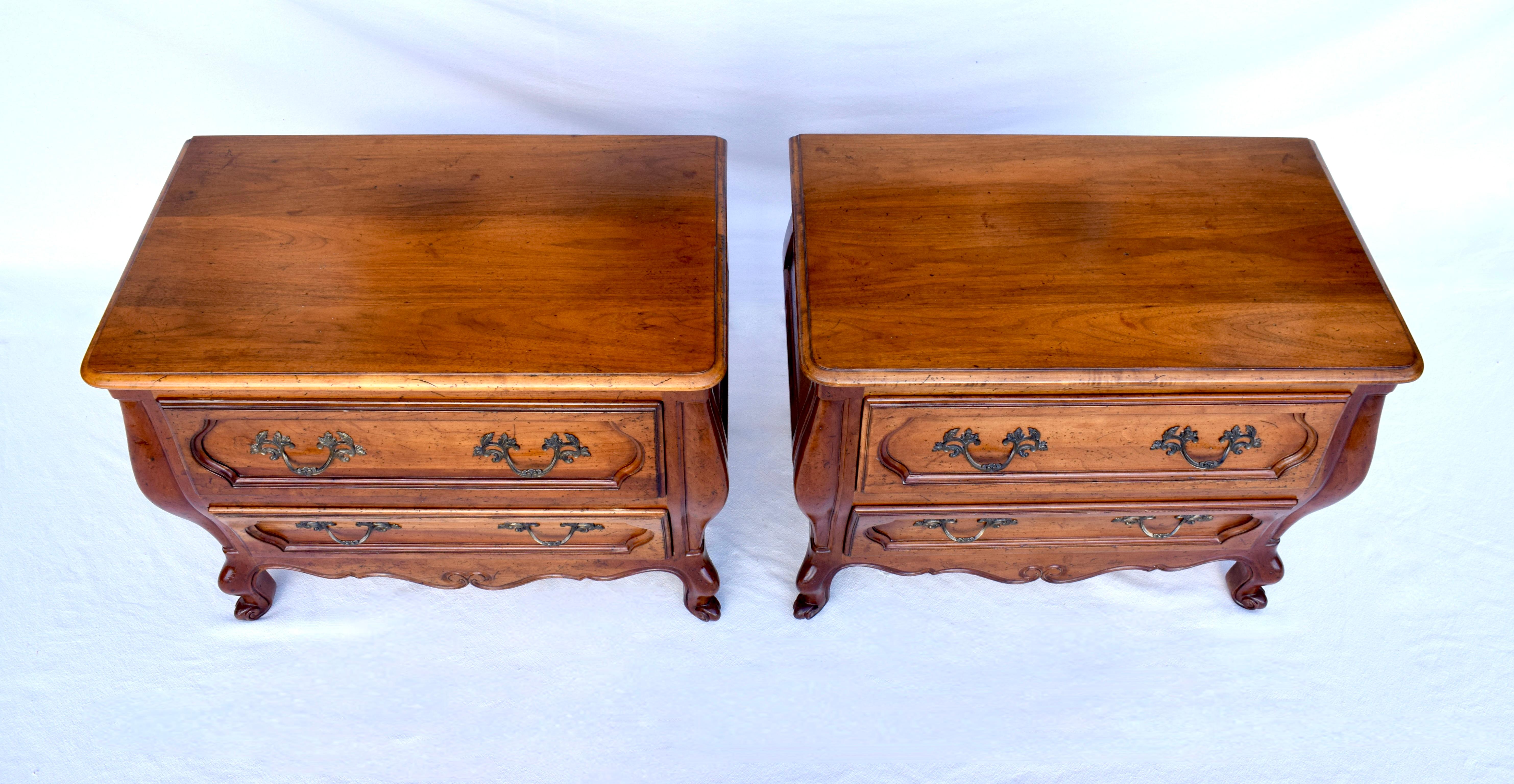 Magnificent French Provincial nightstands finely crafted by Baker Furniture. Grand in scale with a bombe silhouette featuring curvaceous apron, sweet cabriole legs and intricate hardware. These lovely bedside chests will add Country French charm to