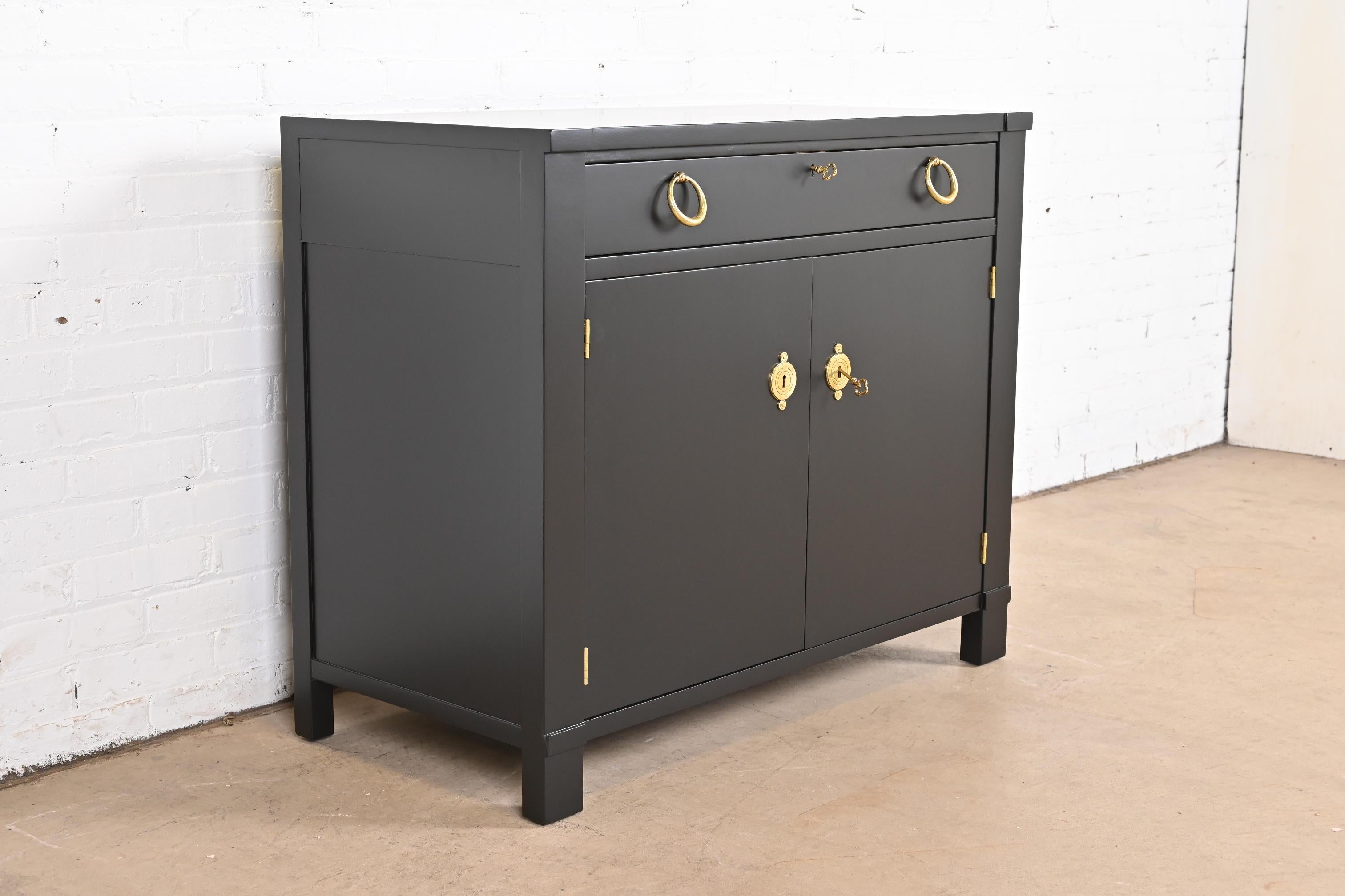 An exceptional French Regency or Neoclassical compact credenza, sideboard buffet, or bar cabinet

By Baker Furniture

USA, 1960s

Black lacquered cherry wood, with original brass hardware.

Measures: 38