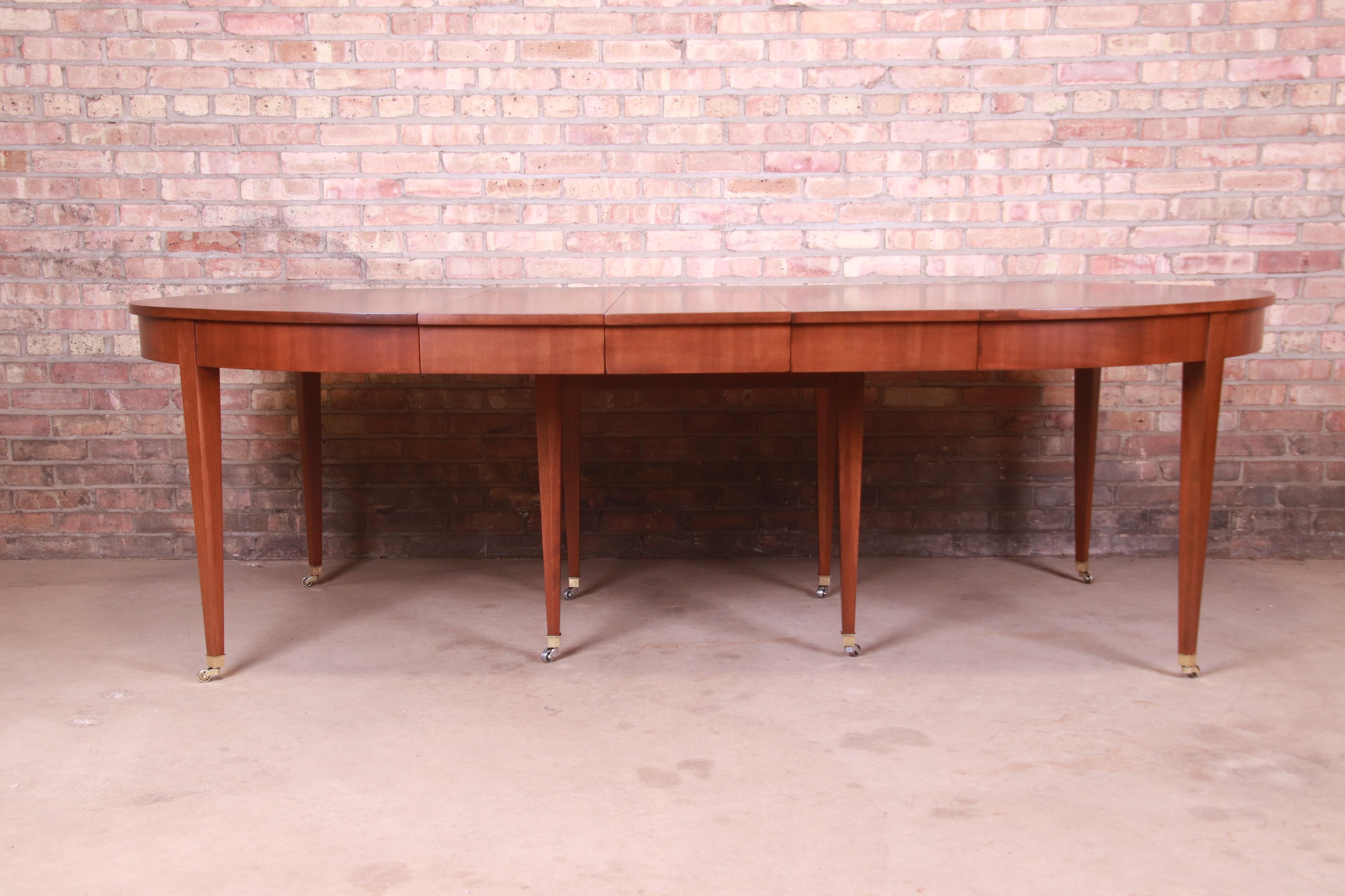 A gorgeous mid-century modern French Regency style extension dining table

By Baker Furniture

USA, Circa 1960s

Cherry wood, with brass-capped feet and casters.

Measures: 55.25