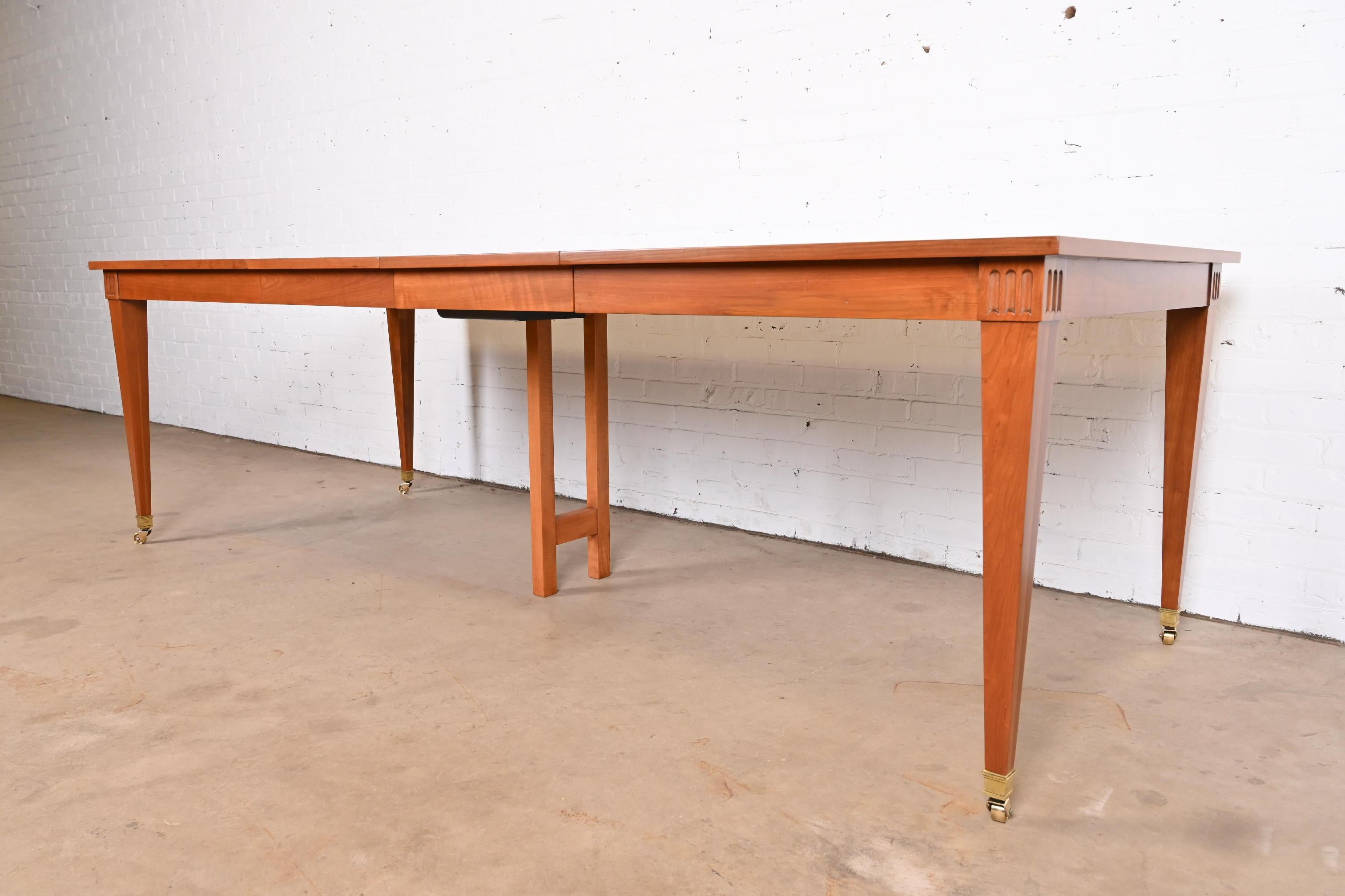 A gorgeous French Regency style extension dining table

By Baker Furniture

USA, Circa 1960s

Cherry wood, with inlaid parquetry top, brass-capped feet, and brass casters.

Measures: 60