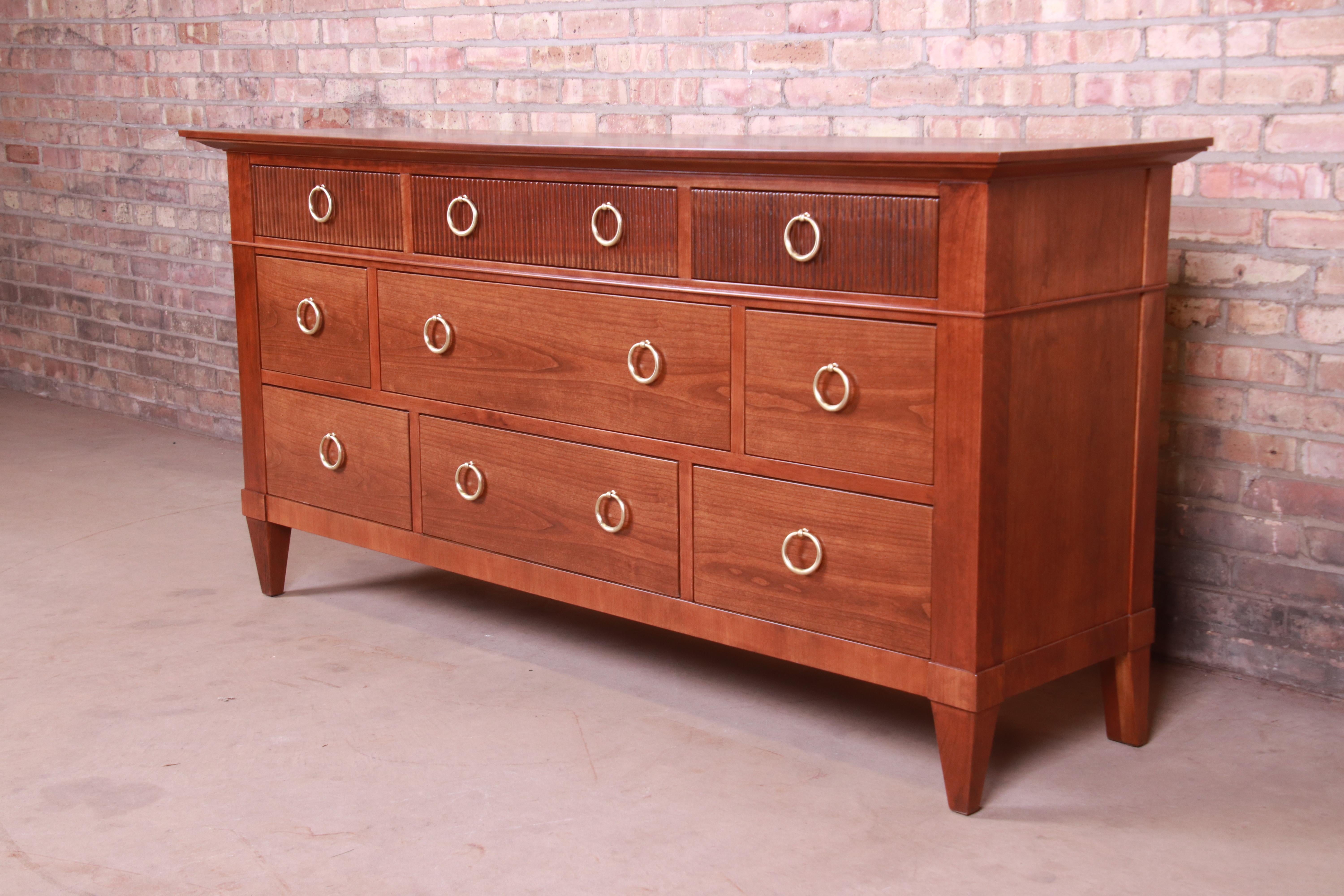 An exceptional midcentury French Regency style nine-drawer dresser or credenza

By Baker Furniture

USA, circa 1960s

Solid cherrywood, with original brass hardware.

Measures: 70.13