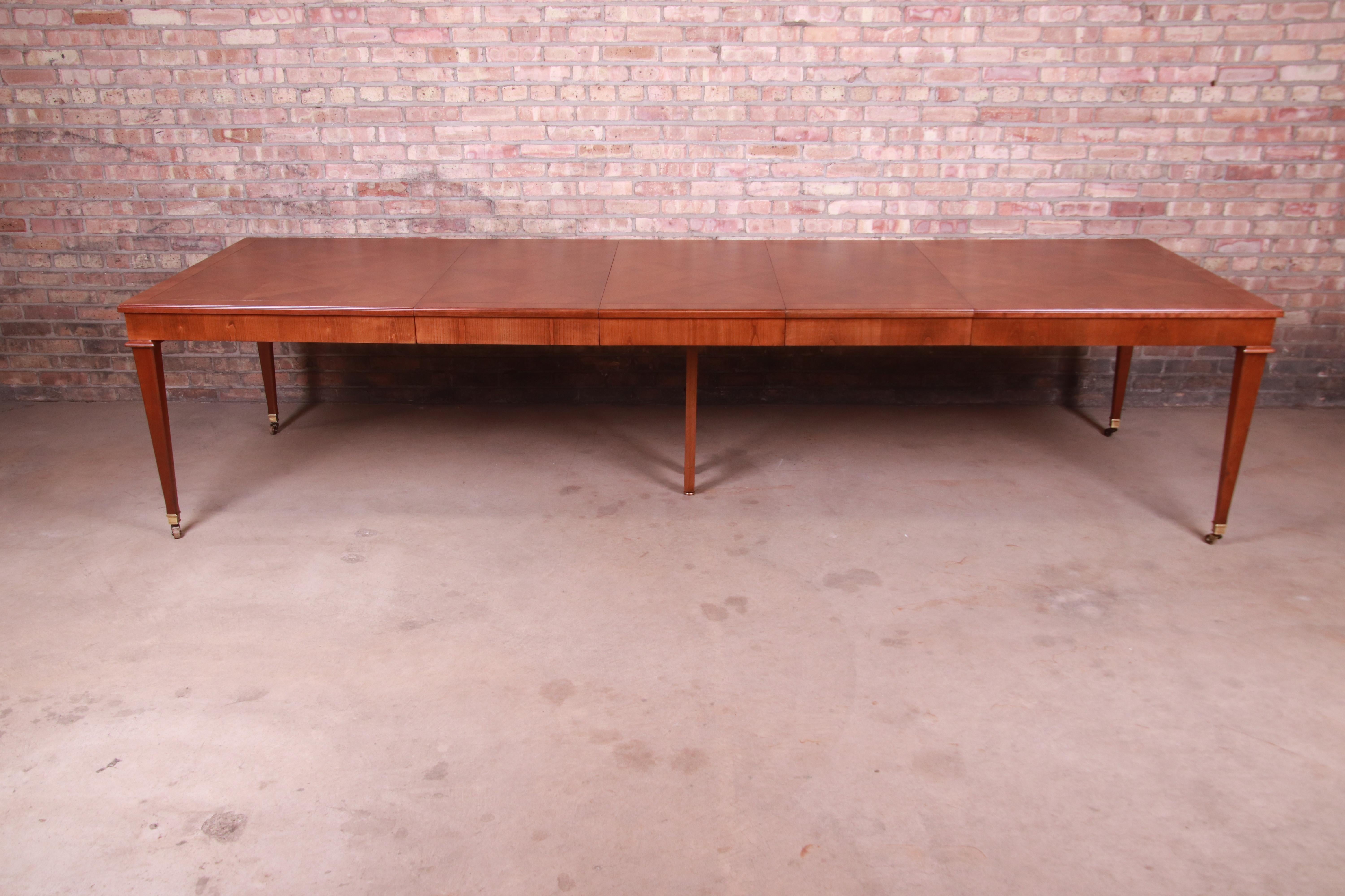 A gorgeous French Regency style extension dining table

By Baker Furniture

USA, Circa 1960s

Cherry wood, with inlaid parquetry top and brass-capped feet.

Measures: 66.75