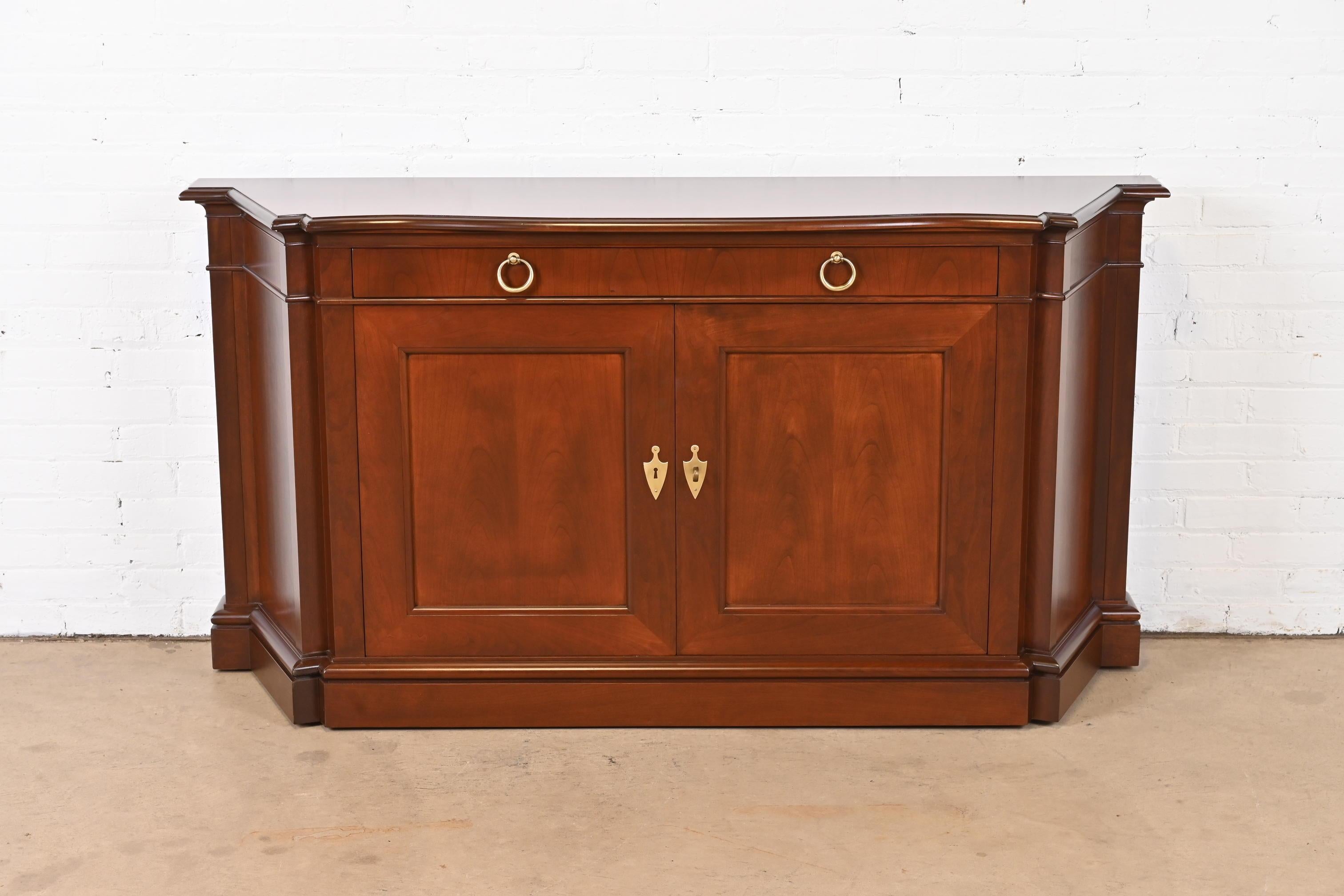 An exceptional French Regency style sideboard, credenza, or bar cabinet

By Baker Furniture

USA, Circa 1960s

Gorgeous book-matched cherry wood, with original brass hardware. Cabinet locks, and key is included.

Measures: 65.5