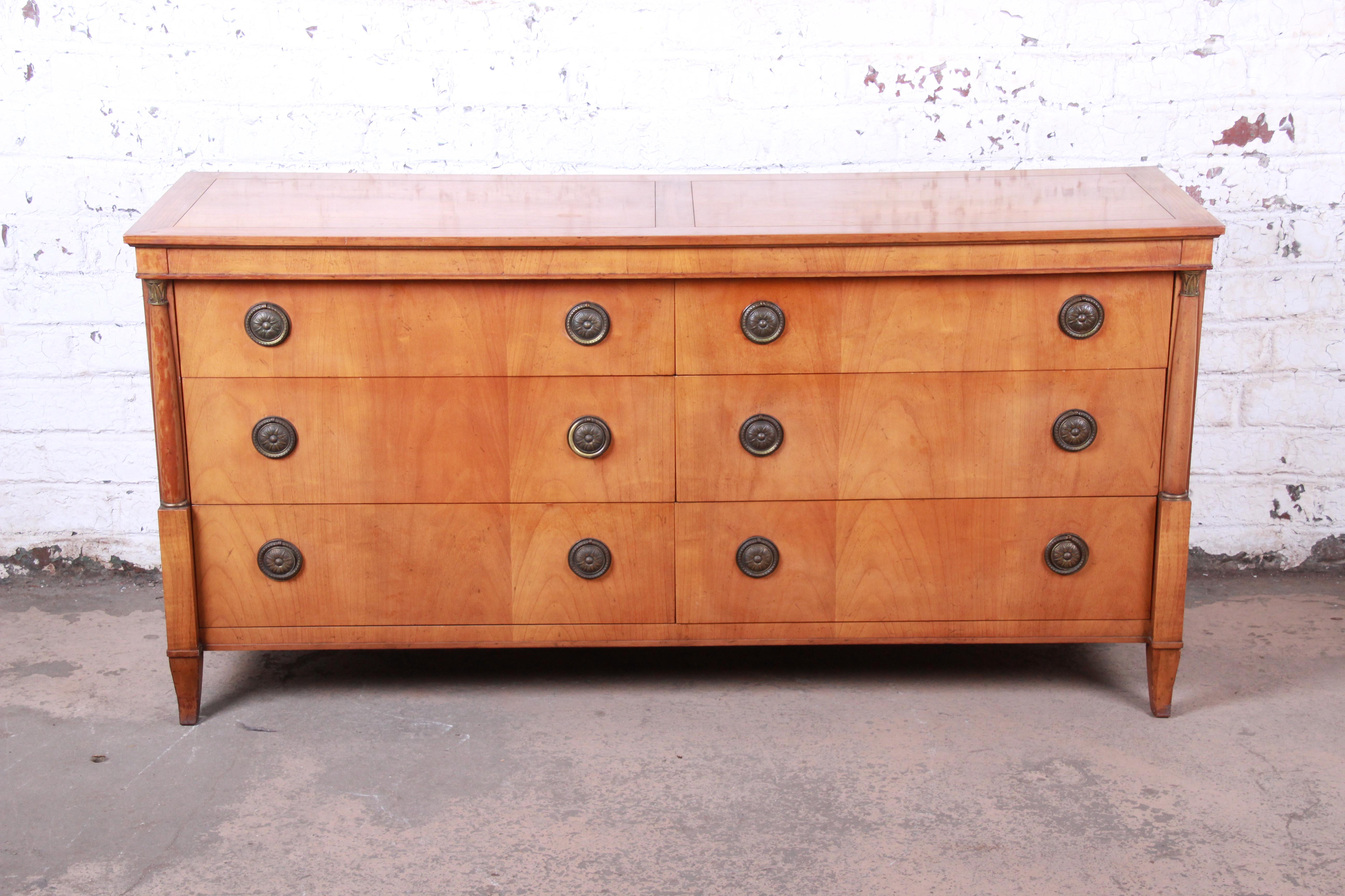 An exceptional French Regency style six-drawer long dresser or credenza

By Baker Furniture

USA, circa 1960s

Bookmatched cherry and brass

Measures: 64