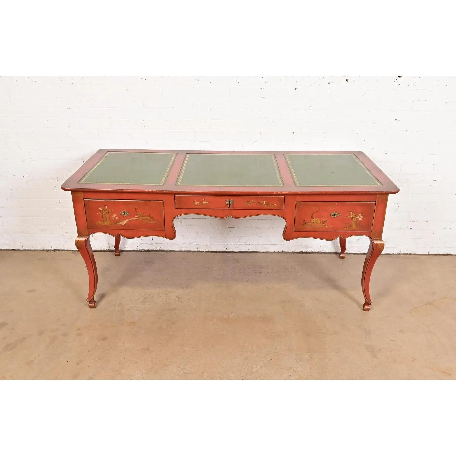 A gorgeous French Regency Chinoiserie style writing desk or bureau plat desk

By Baker Furniture

USA, Circa 1960s

Red lacquered walnut, with hand-painted Asian nature scenes, embossed green leather top, and original brass hardware.

Measures: