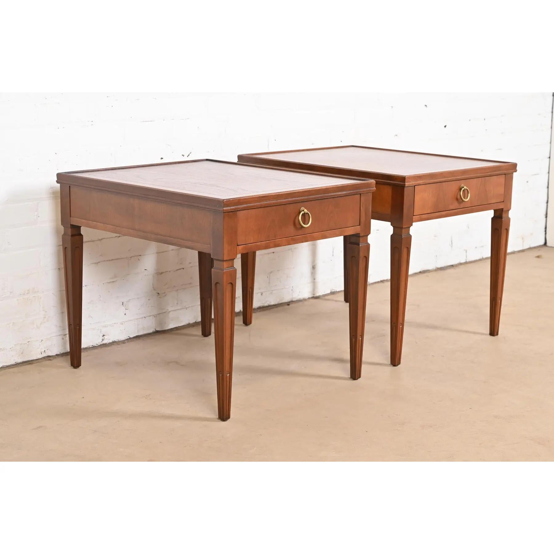A gorgeous pair of French Regency Louis XVI style nightstands, tea tables, or end tables

By Baker Furniture

USA, Circa 1960s

Carved cherry wood, with stunning book-matched burled walnut tops, and original brass hardware.

Each measures: 22