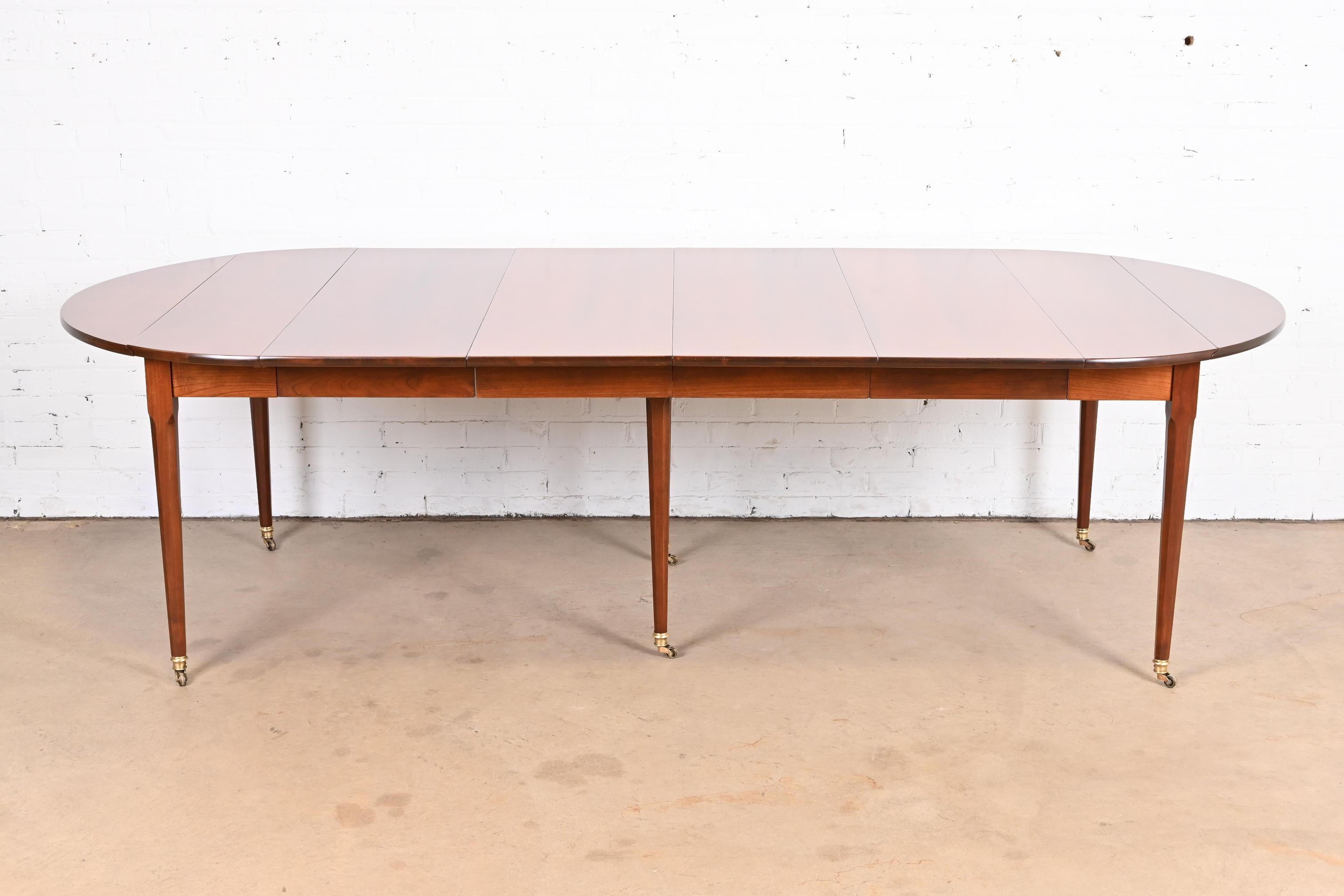 A gorgeous French Regency Louis XVI style extension drop leaf dining table

By Baker Furniture

USA, circa 1960s

Solid cherry wood, with brass sabots and castors.

Measures: 104.25