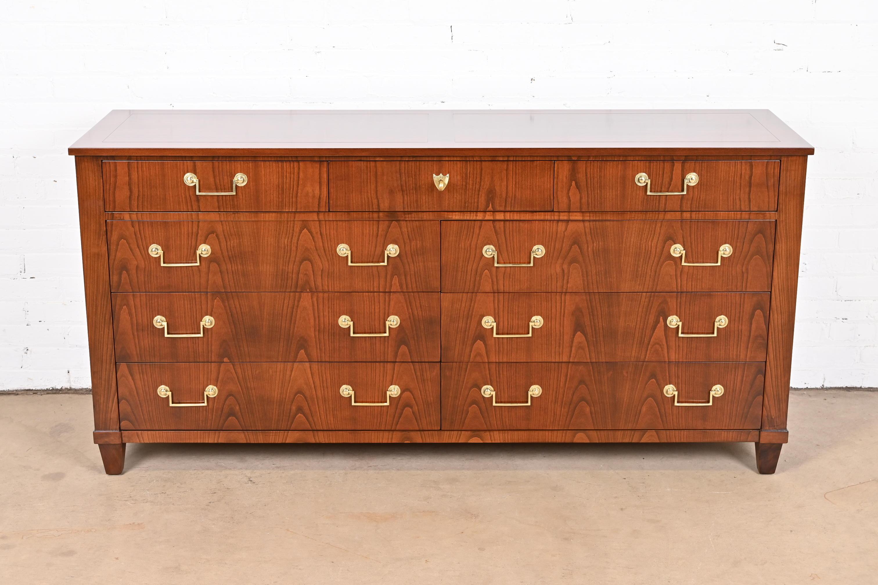 An exceptional French Regency Louis XVI style nine-drawer dresser or credenza

By Baker Furniture

USA, circa 1960s

Gorgeous book-matched cherry wood, with original brass hardware. Top middle drawer locks, and key is included.

Measures: