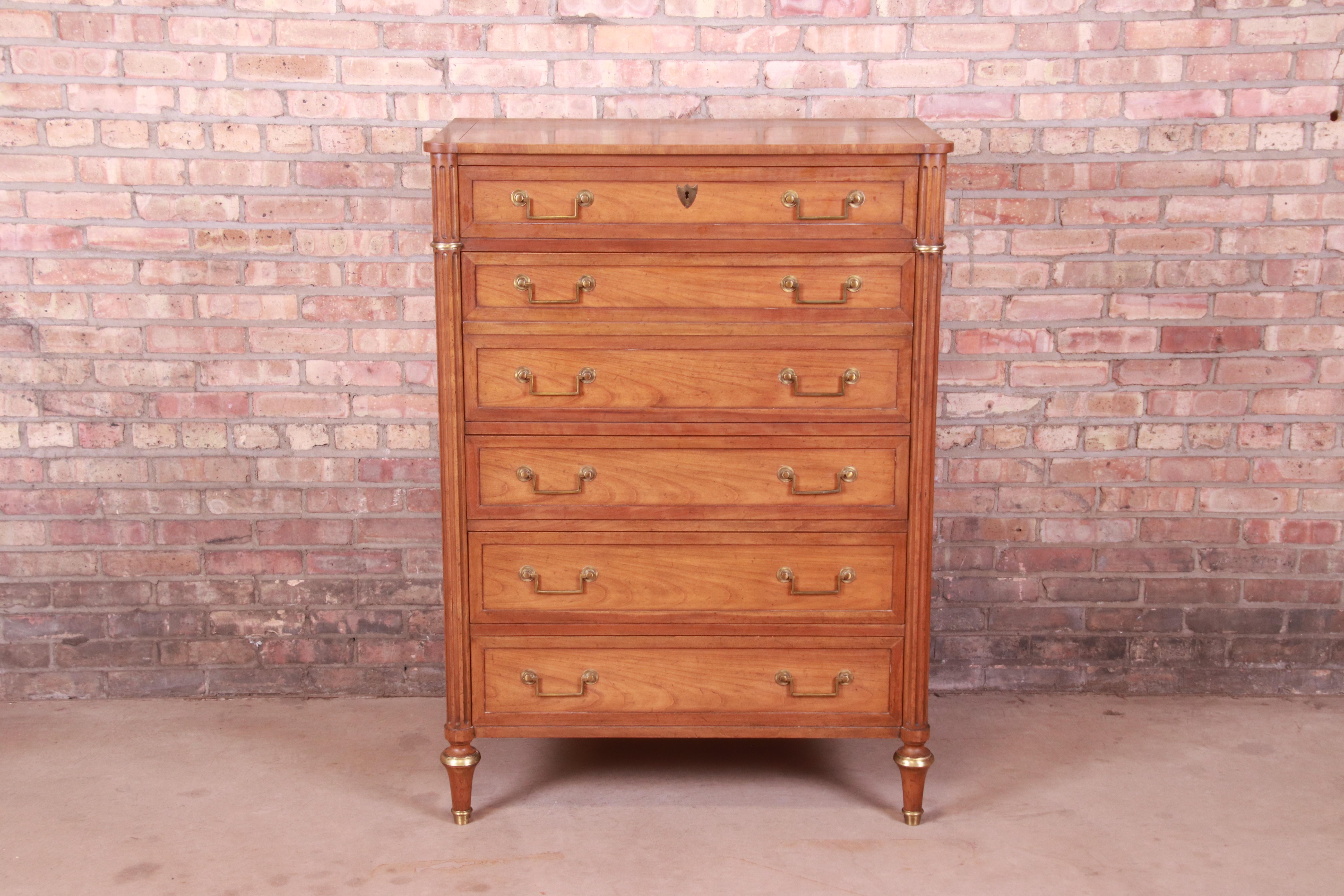 A gorgeous French Regency Louis XVI style highboy chest of drawers

By Baker Furniture

USA, Circa 1960s

Cherry wood, with original brass hardware and accents.

Measures: 36.25