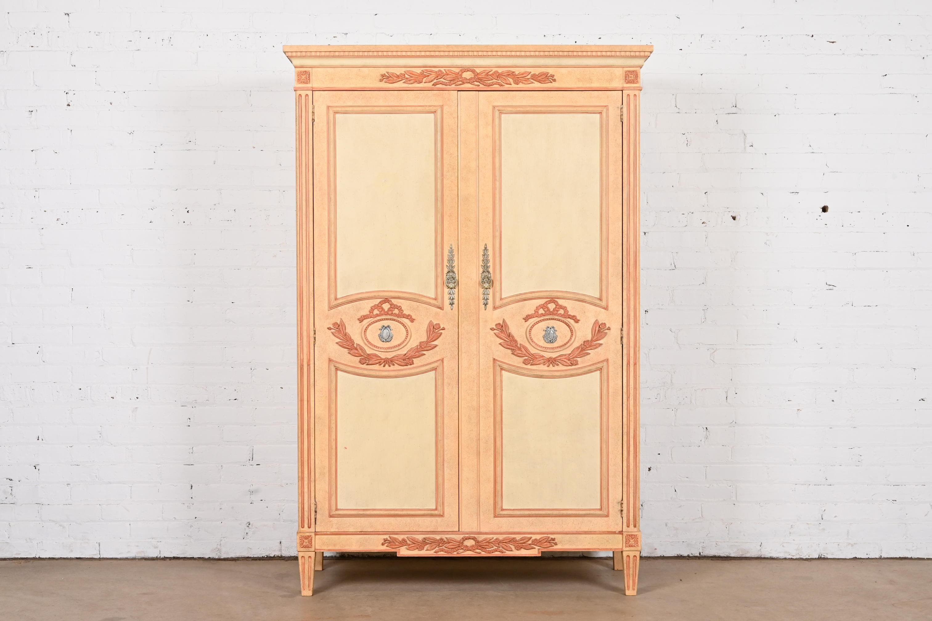 A gorgeous French Regency Louis XVI or Swedish Gustavian style armoire dresser or gentleman's chest

By Baker Furniture

USA, 1960s

Carved cream painted walnut, with peachy pink trim and accents, and original brass hardware.

Measures: 44.75