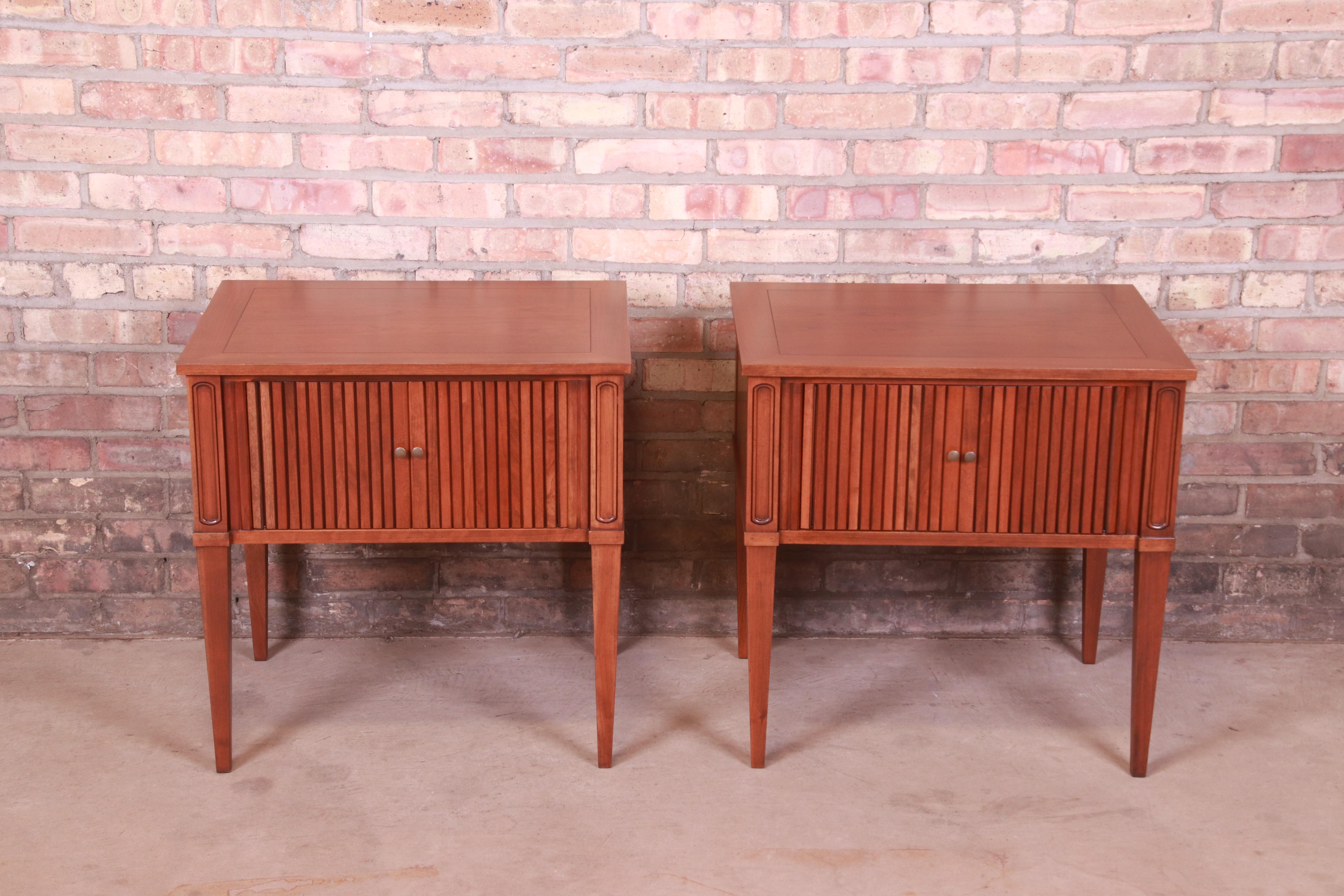 A gorgeous pair of mid-century French Regency Louis XVI style bedside tables or end tables

By Baker Furniture

USA, Circa 1960s

Cherry wood, with original brass hardware.

Measures: 24