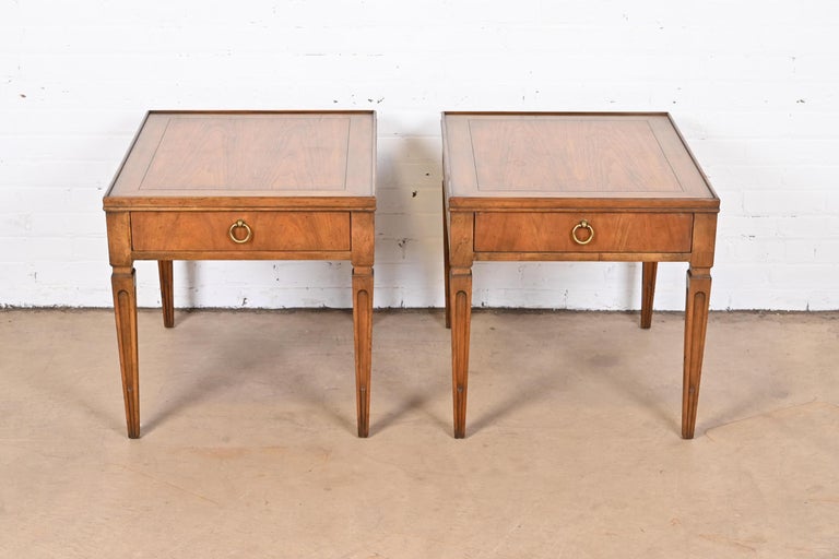 A gorgeous pair of French Regency Louis XVI style nightstands or end tables

By Baker Furniture

USA, Circa 1960s

Carved walnut, with original brass hardware.

Measures: 22