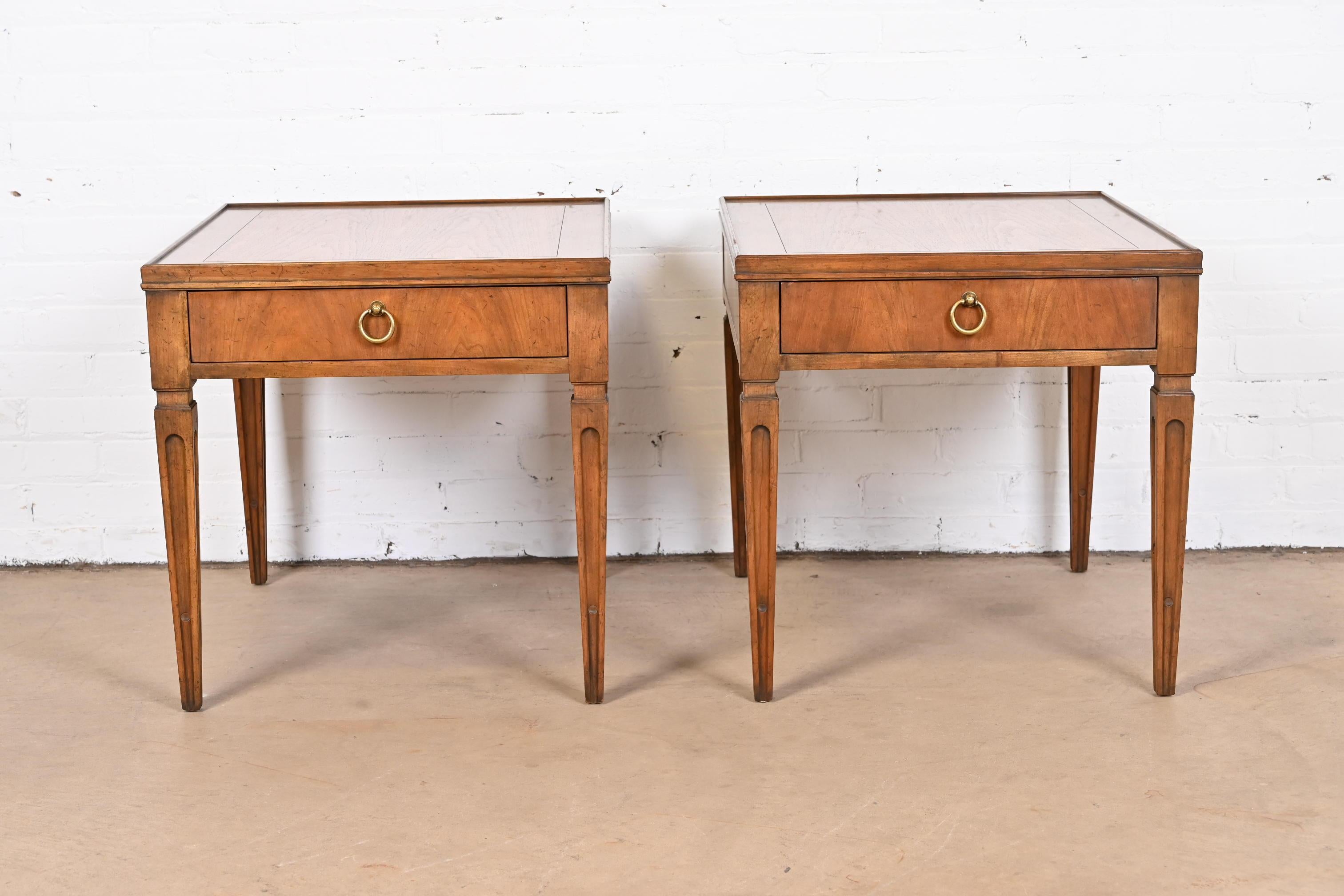A gorgeous pair of French Regency Louis XVI style nightstands or end tables

By Baker Furniture

USA, Circa 1960s

Carved walnut, with original brass hardware.

Measures: 22