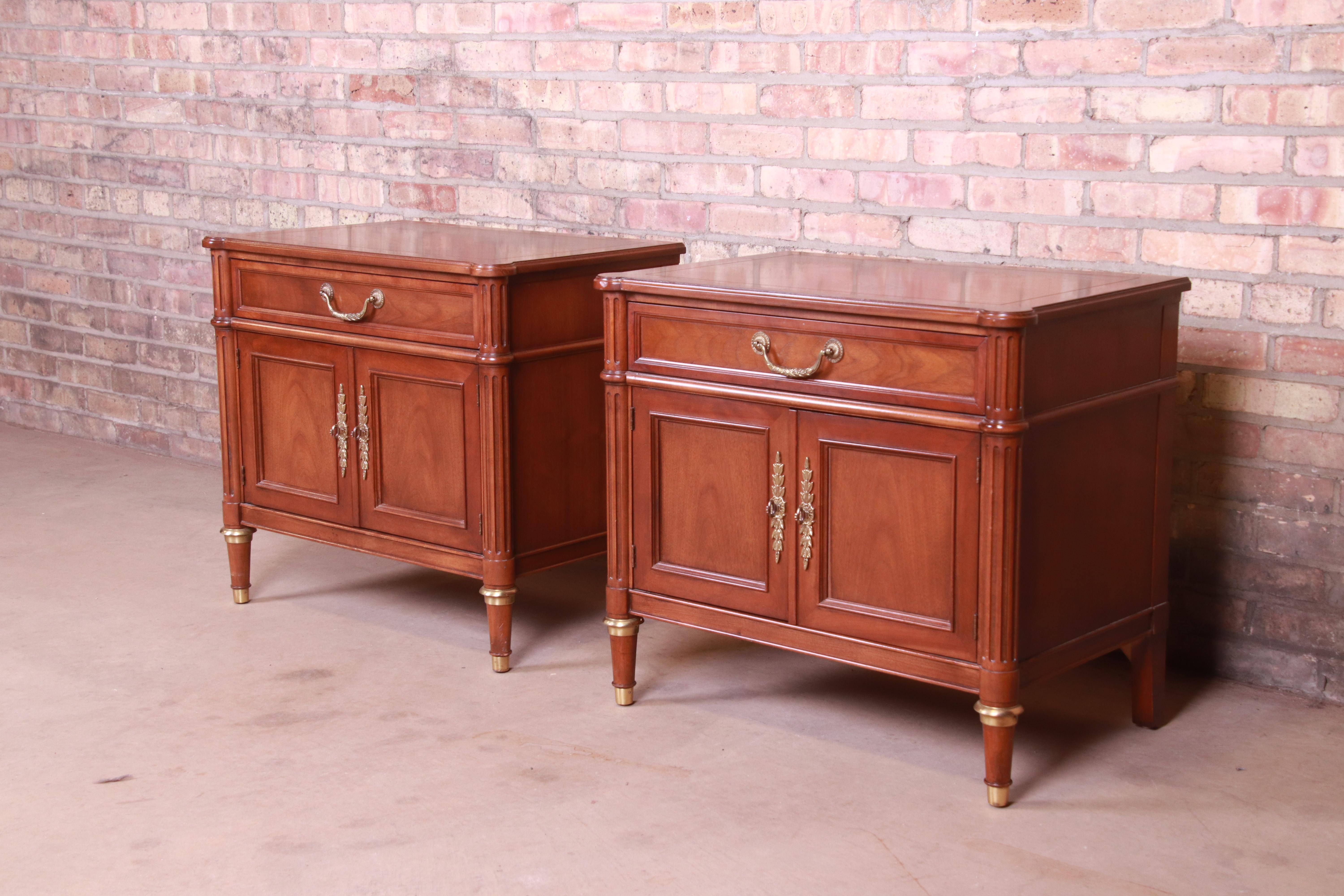 A gorgeous pair of French Regency Louis XVI style nightstands

By Baker Furniture

USA, circa 1980s

Book-matched walnut, with original brass hardware and accents.

Measures: 28