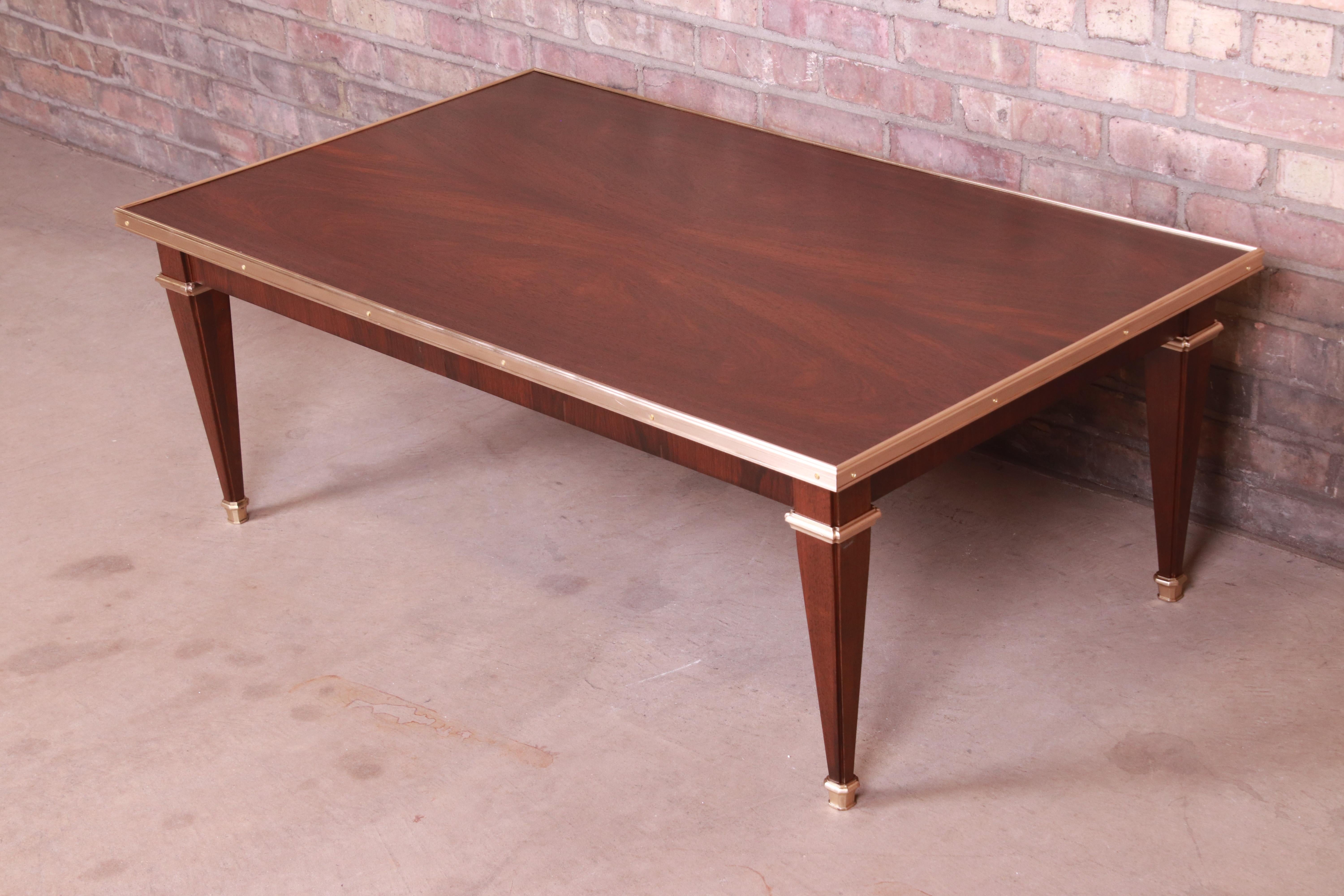 An exceptional French Regency Directoire style coffee or cocktail table

By Baker Furniture

USA, Circa 1960s

Rosewood, with brass trim and accents.

Measures: 44.25