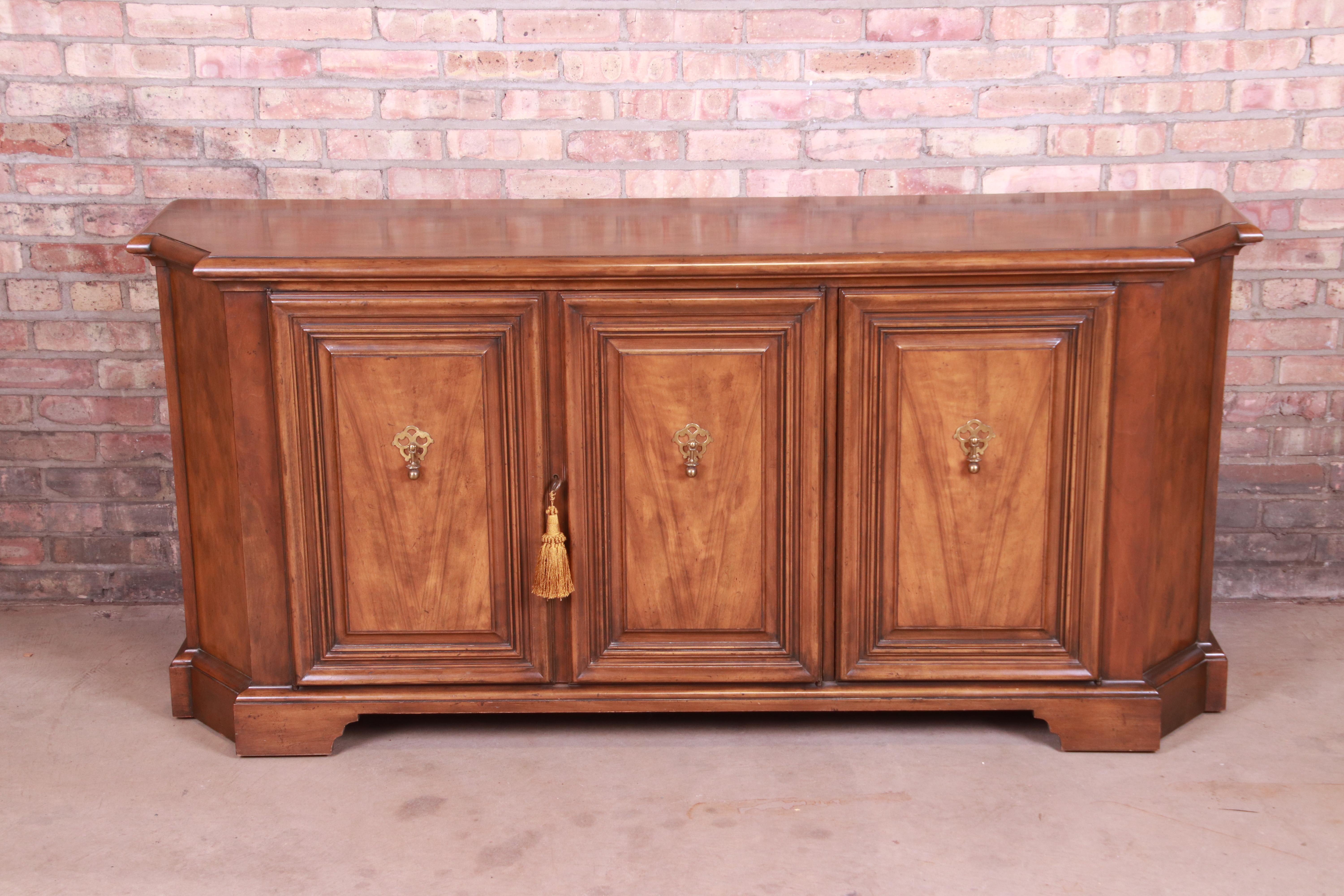 A gorgeous French Regency style sideboard, credenza, or bar cabinet

By Baker Furniture

USA, mid-20th century

Walnut, with original brass hardware.

Measures: 69