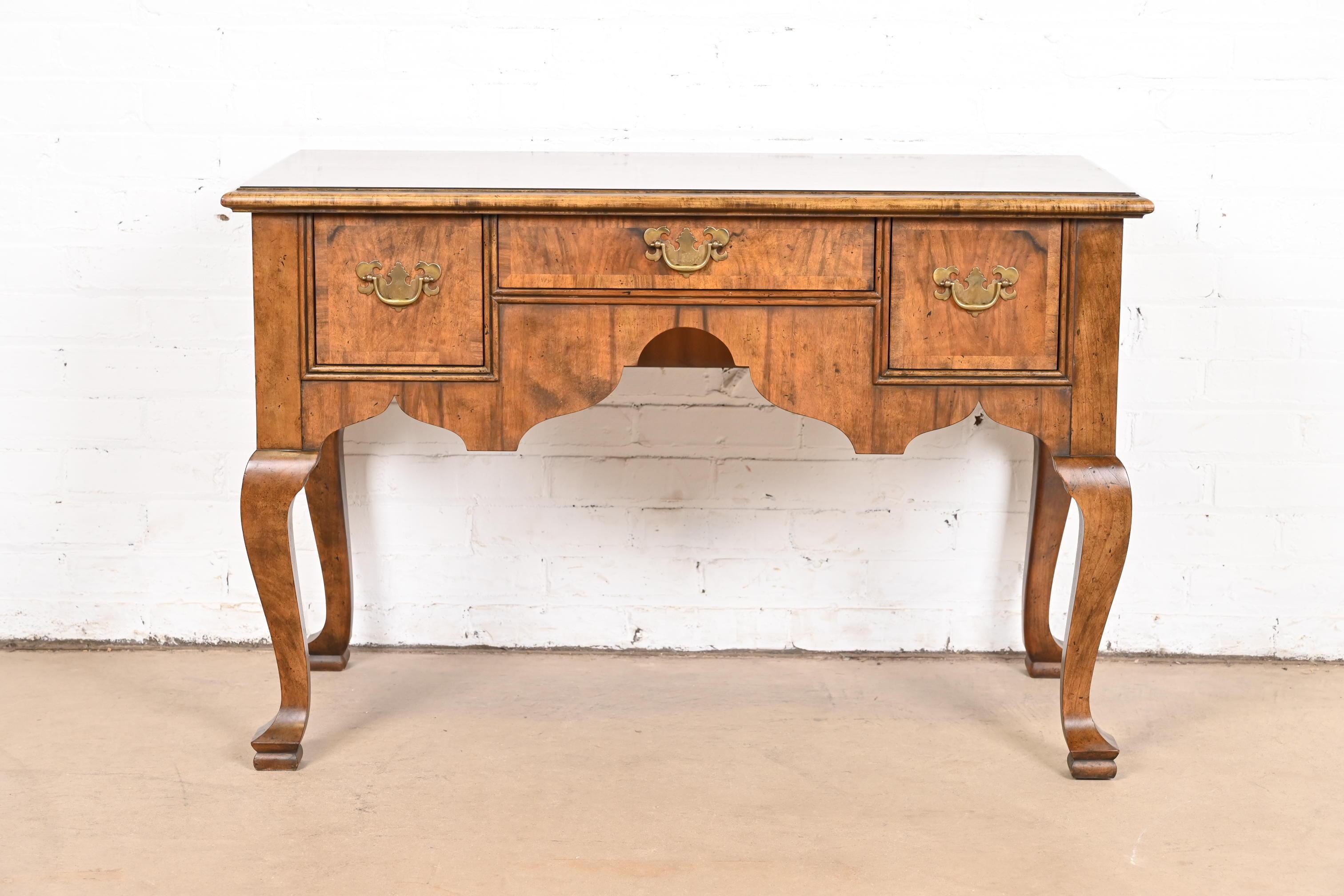 An exceptional Georgian, Chippendale, or Queen Anne style sideboard buffet, server, console, or lowboy dresser

By Baker Furniture

USA, Circa 1980s

Gorgeous banded burled walnut, with original brass hardware

Measures: 40