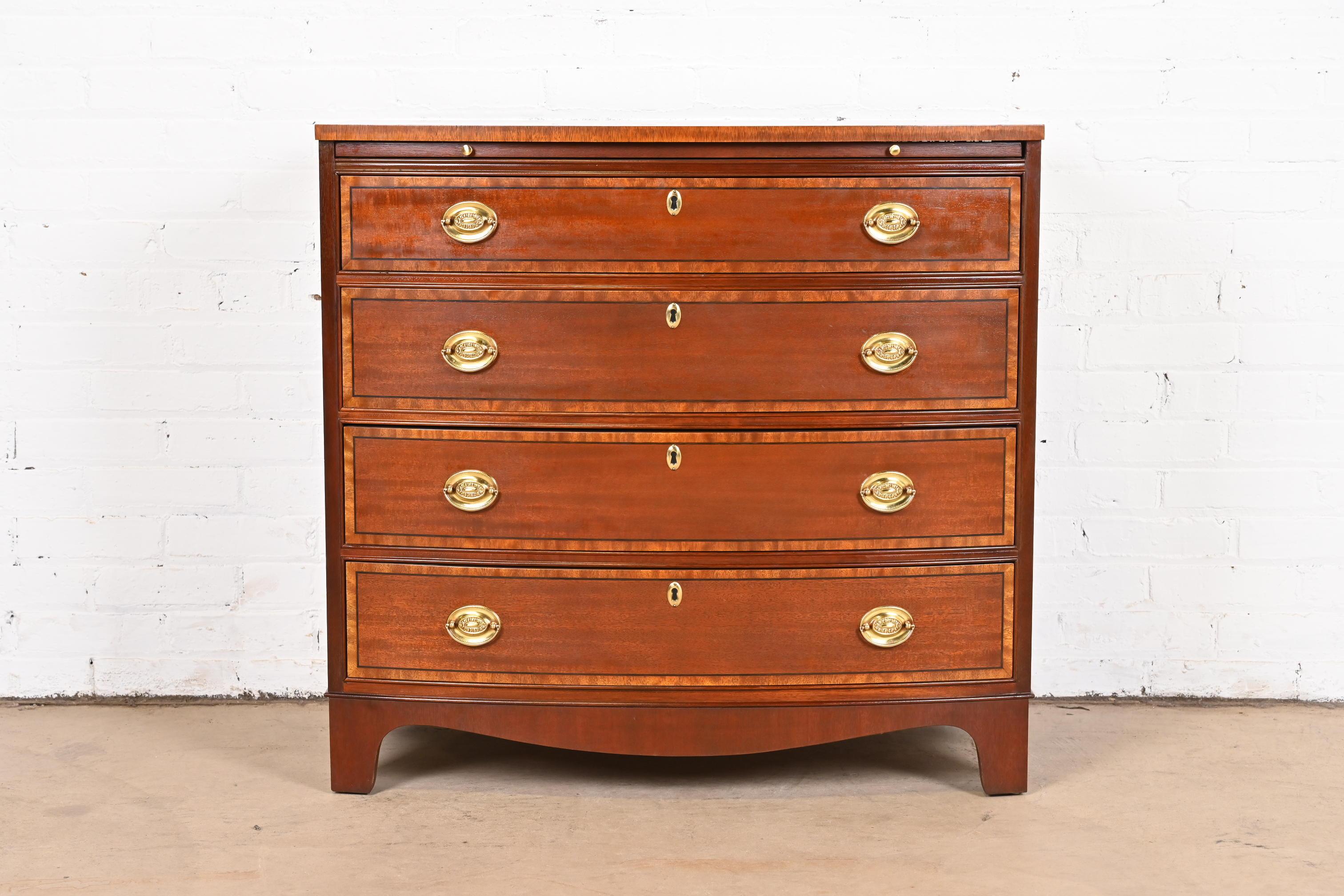 A gorgeous Georgian style bow front four-drawer commode, dresser, or chest of drawers

By Baker Furniture

USA, circa 1980s

Mahogany, with satinwood banding and original brass hardware.

Measures: 34
