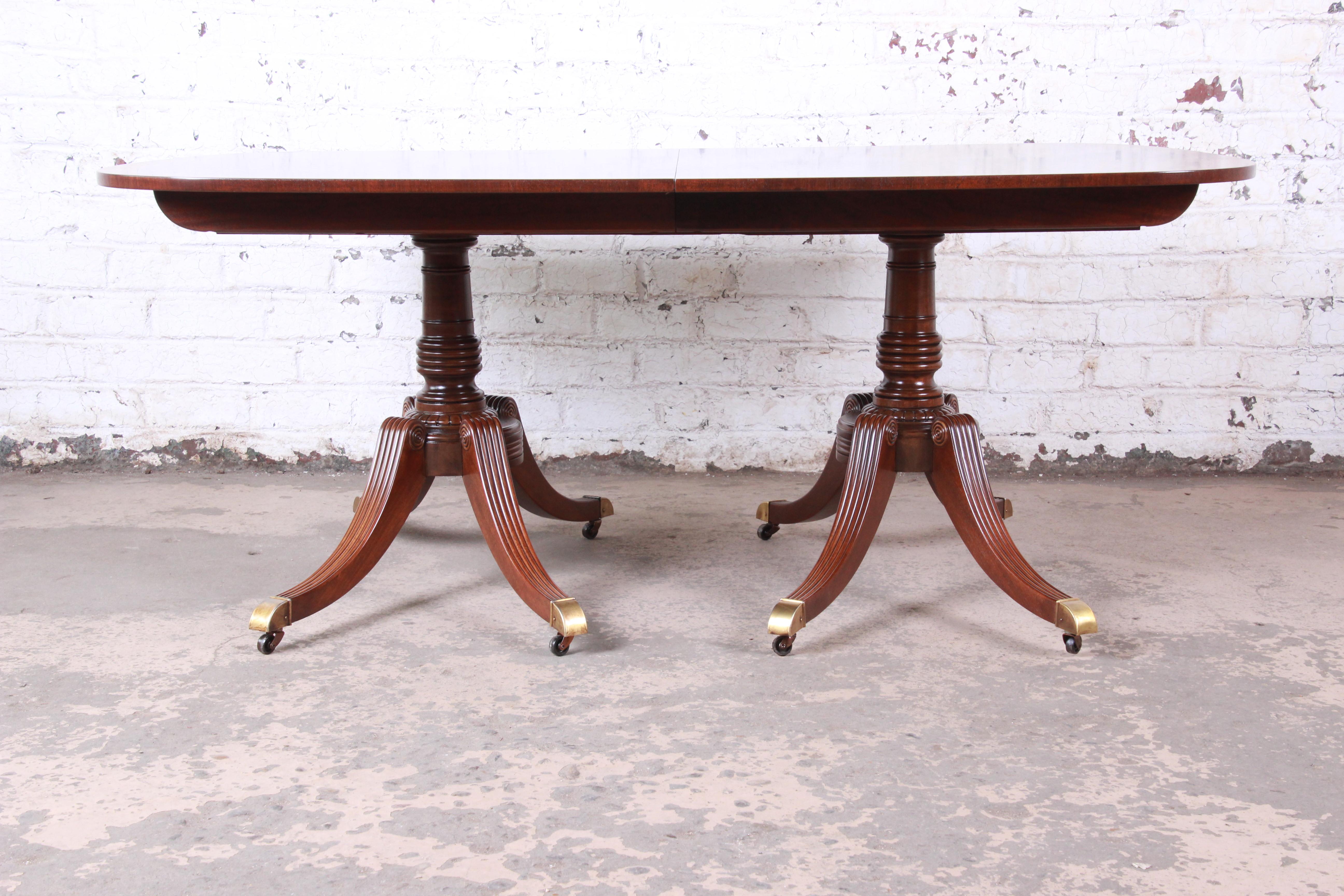An exceptional Georgian banded mahogany double pedestal extension dining table

By Baker Furniture

USA, circa 1950

Mahogany + satinwood + brass

Measures: 68