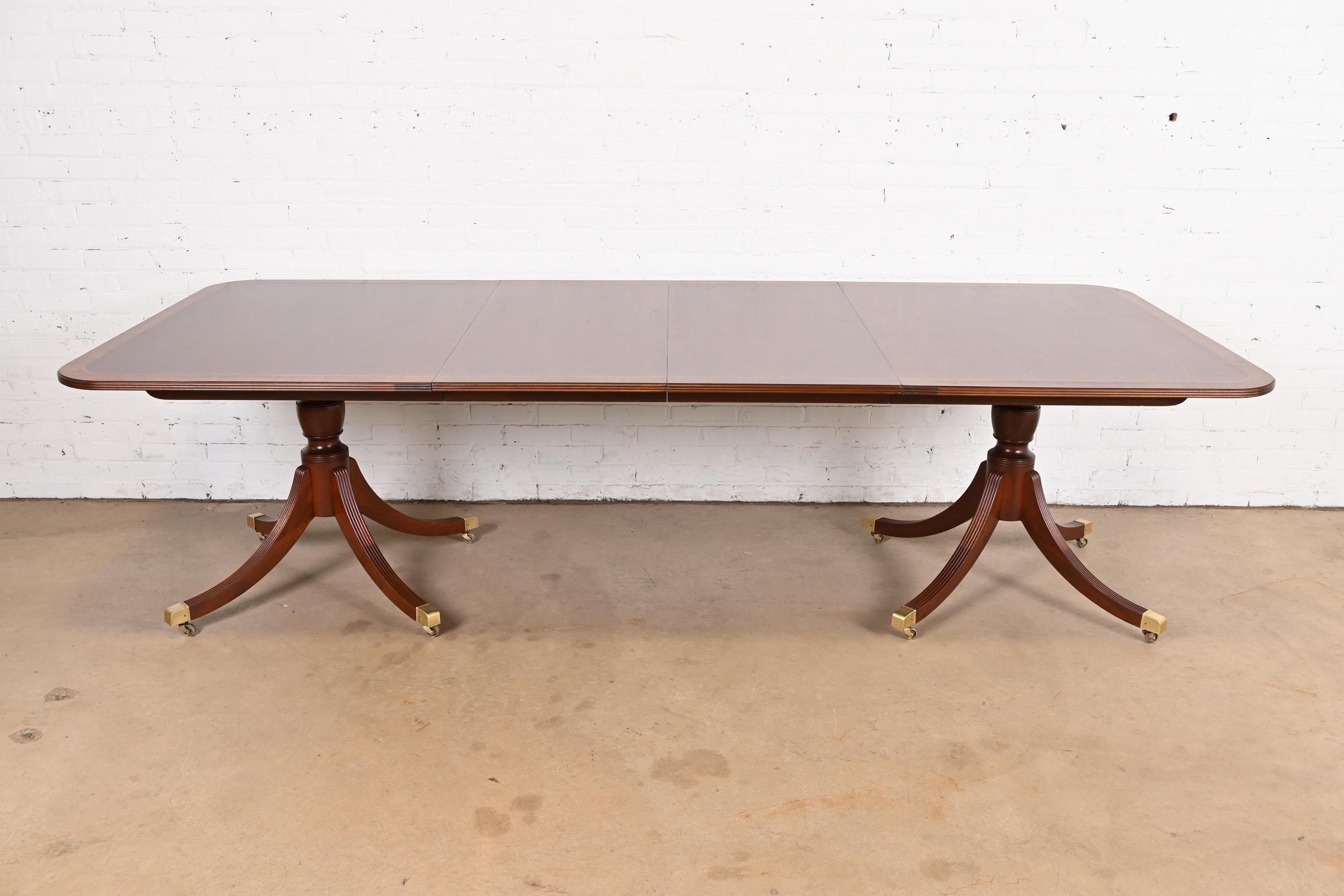 An exceptional Georgian or Regency style double pedestal extension dining table

By Baker Furniture, 