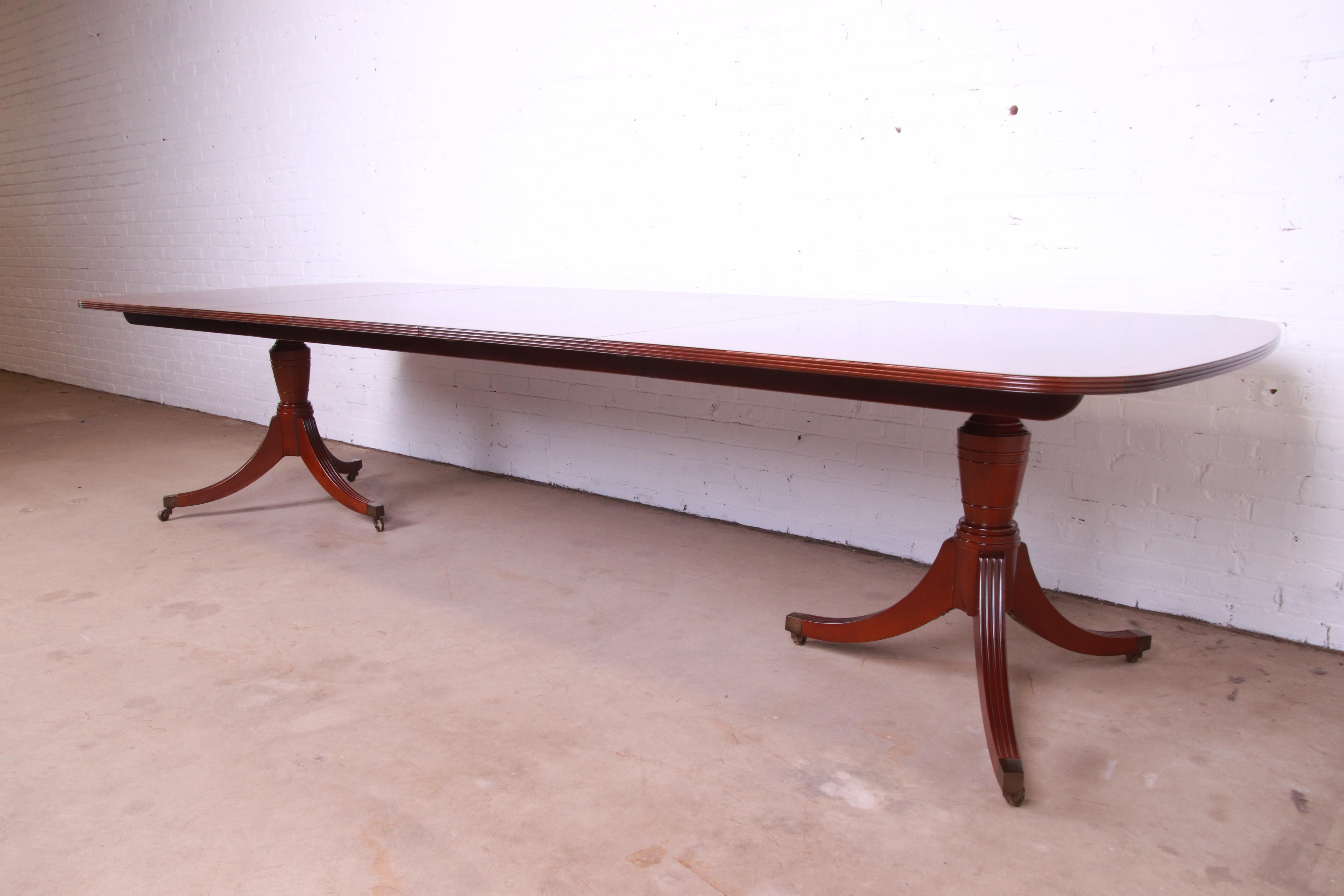 20th Century Baker Furniture Georgian Banded Mahogany Double Pedestal Extension Dining Table