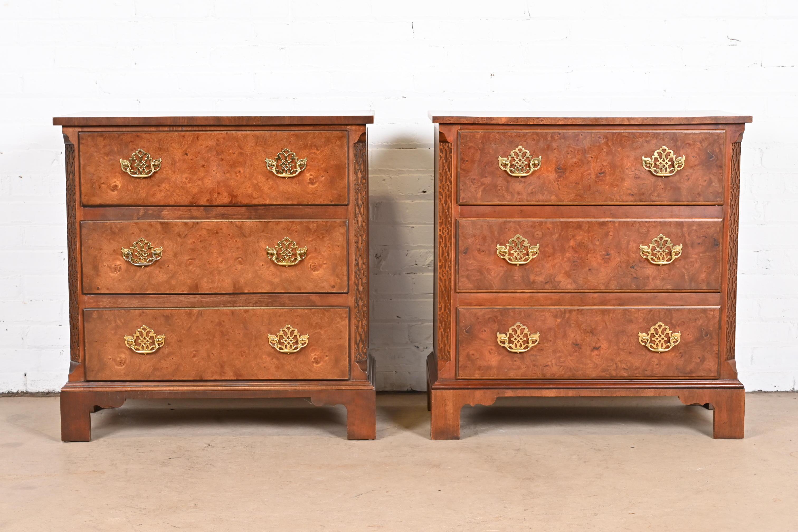 A beautiful pair of Georgian or Chippendale style three-drawer bachelor chests or nightstands

By Baker Furniture

USA, circa 1980s

Book-matched carved walnut cases, with gorgeous burled walnut drawer fronts and original brass
