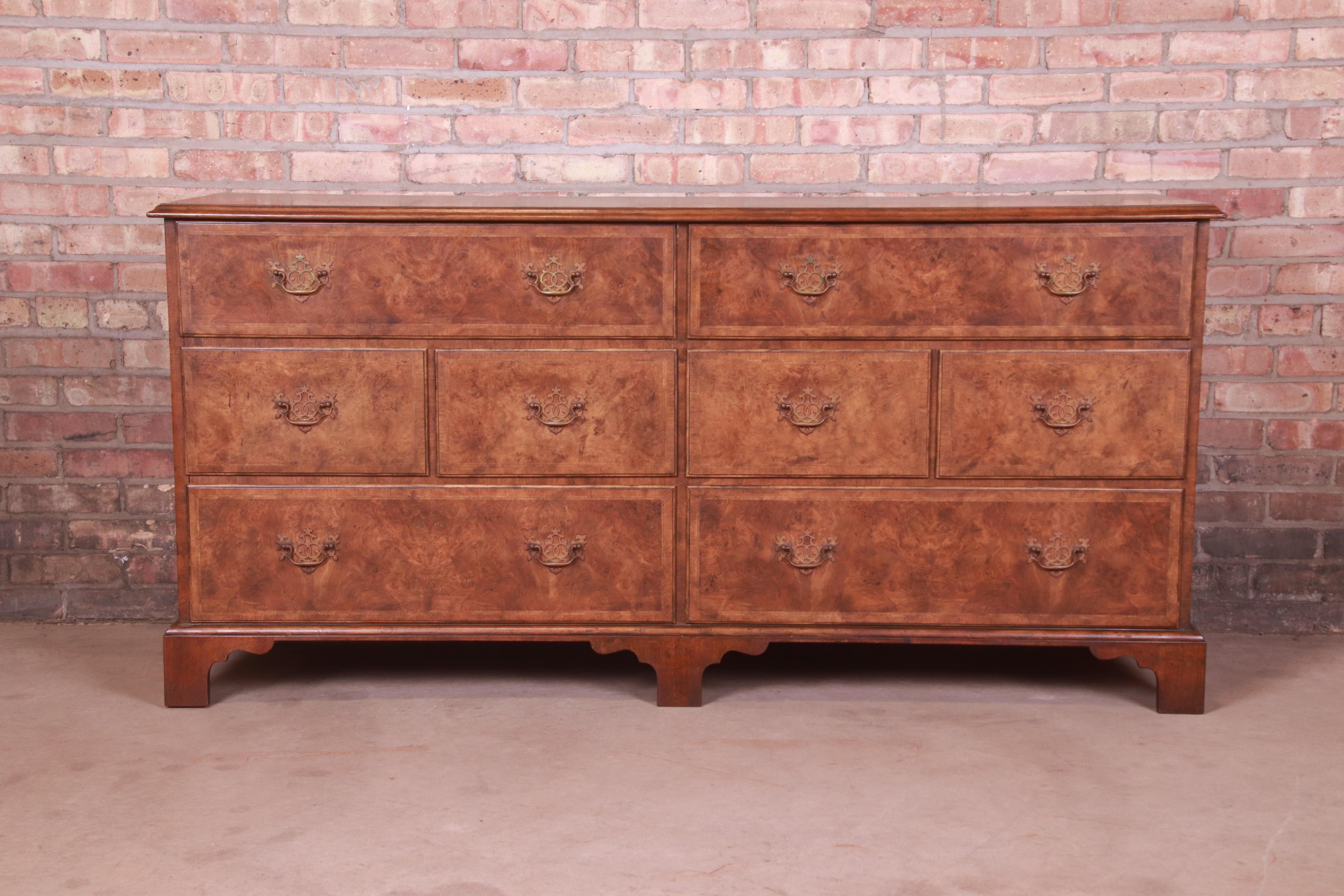 A gorgeous Georgian style eight-drawer double dresser or credenza

By Baker Furniture

USA, Circa 1960s

Gorgeous inlaid burled walnut drawer fronts, with walnut case and original brass hardware.

Measures: 66