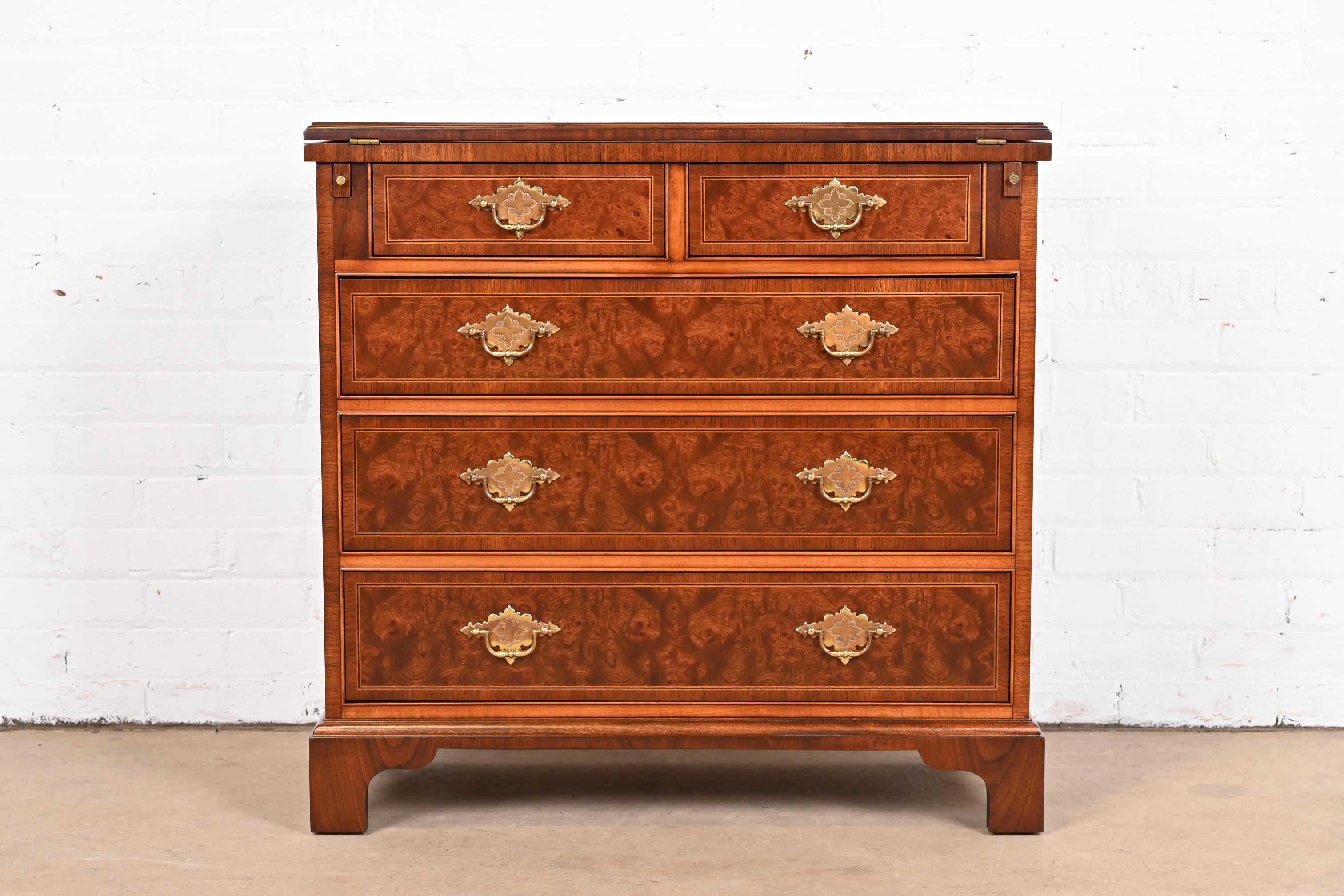 An exceptional Georgian or Chippendale style flip top dresser or bachelor chest of drawers

By Baker Furniture

USA, Circa 1980s

Gorgeous book-matched burled walnut, with inlaid satinwood banding and original brass hardware.

Measures: