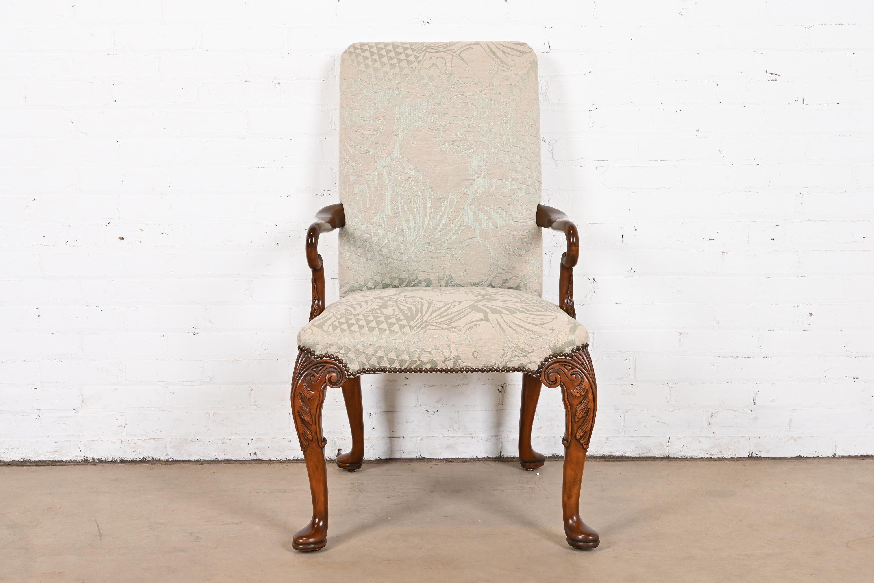 A beautiful Georgian, Chippendale, or Queen Anne style arm chair or lounge chair

By Baker Furniture

USA, Circa 1980s

Carved mahogany frame, with brass studded fruit patterned upholstery.

Measures: 24.5