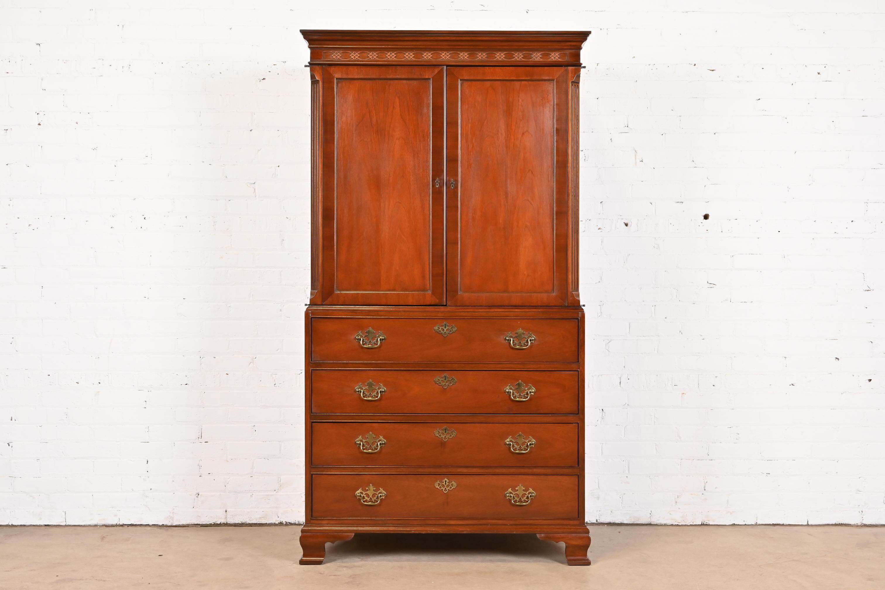 A gorgeous Georgian or Chippendale style armoire dresser or gentleman's chest

By Baker Furniture

USA, Circa 1980s

Carved mahogany, with original brass hardware.

Measures: 39.5