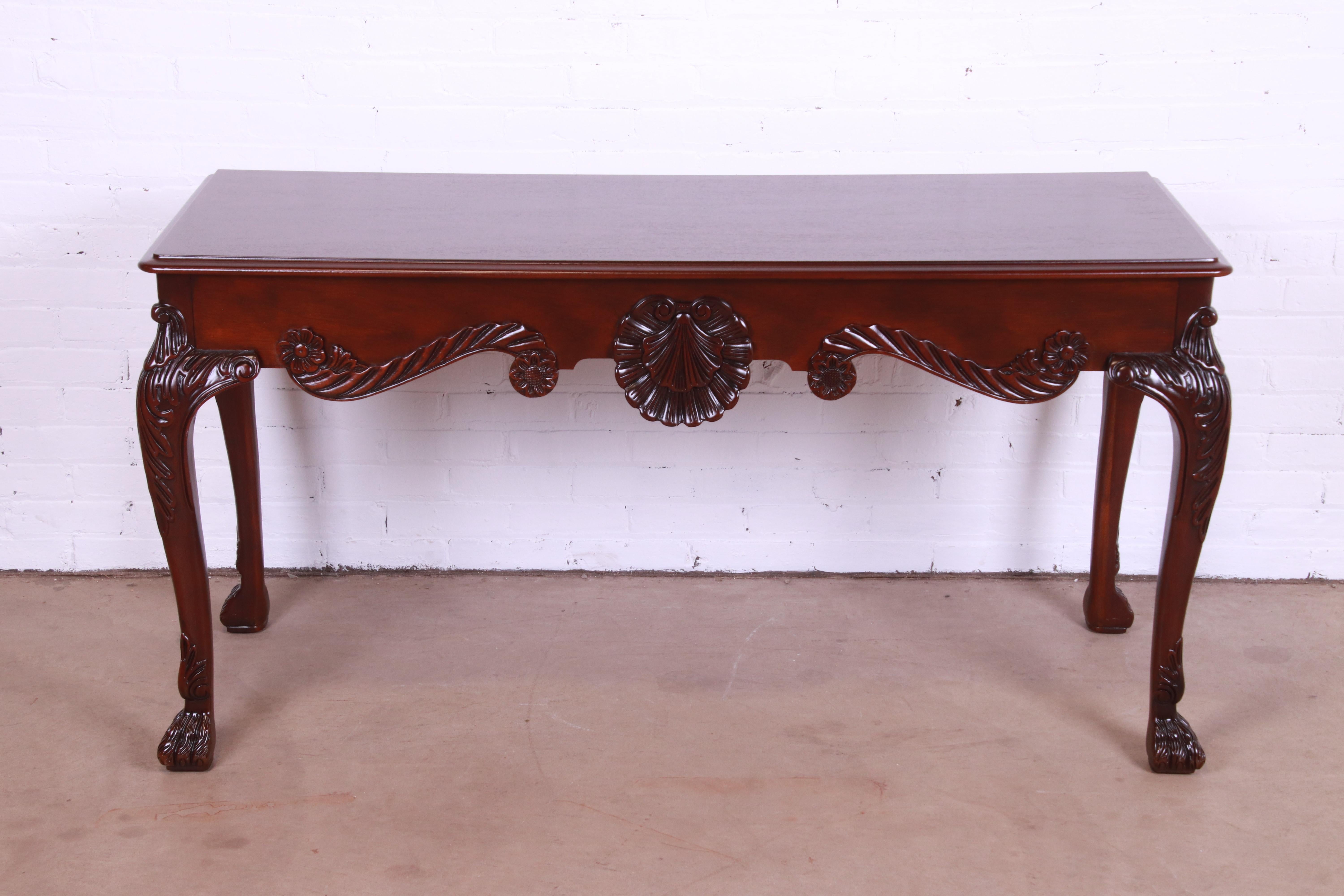 An exceptional Georgian style console or sofa table

By Baker Furniture

USA, Circa 1980s

Carved mahogany, with shell motif and hairy paw feet.

Measures: 58.5