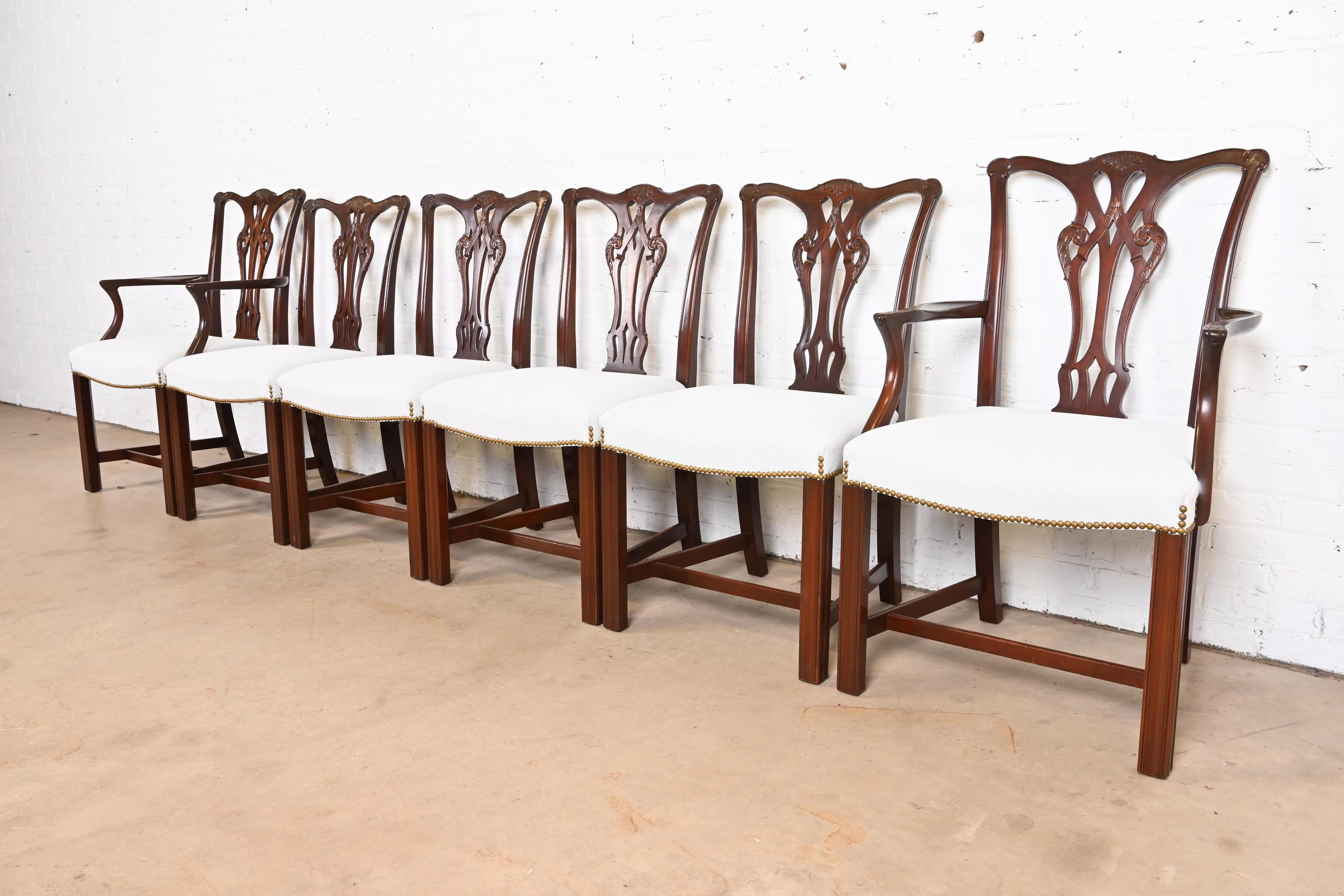 An exceptional set of six Georgian or Chippendale style dining chairs

By Baker Furniture

USA, Circa 1980s

Carved solid mahogany frames, with brass studded white upholstered seats.

Measures:
Side chairs - 21.25