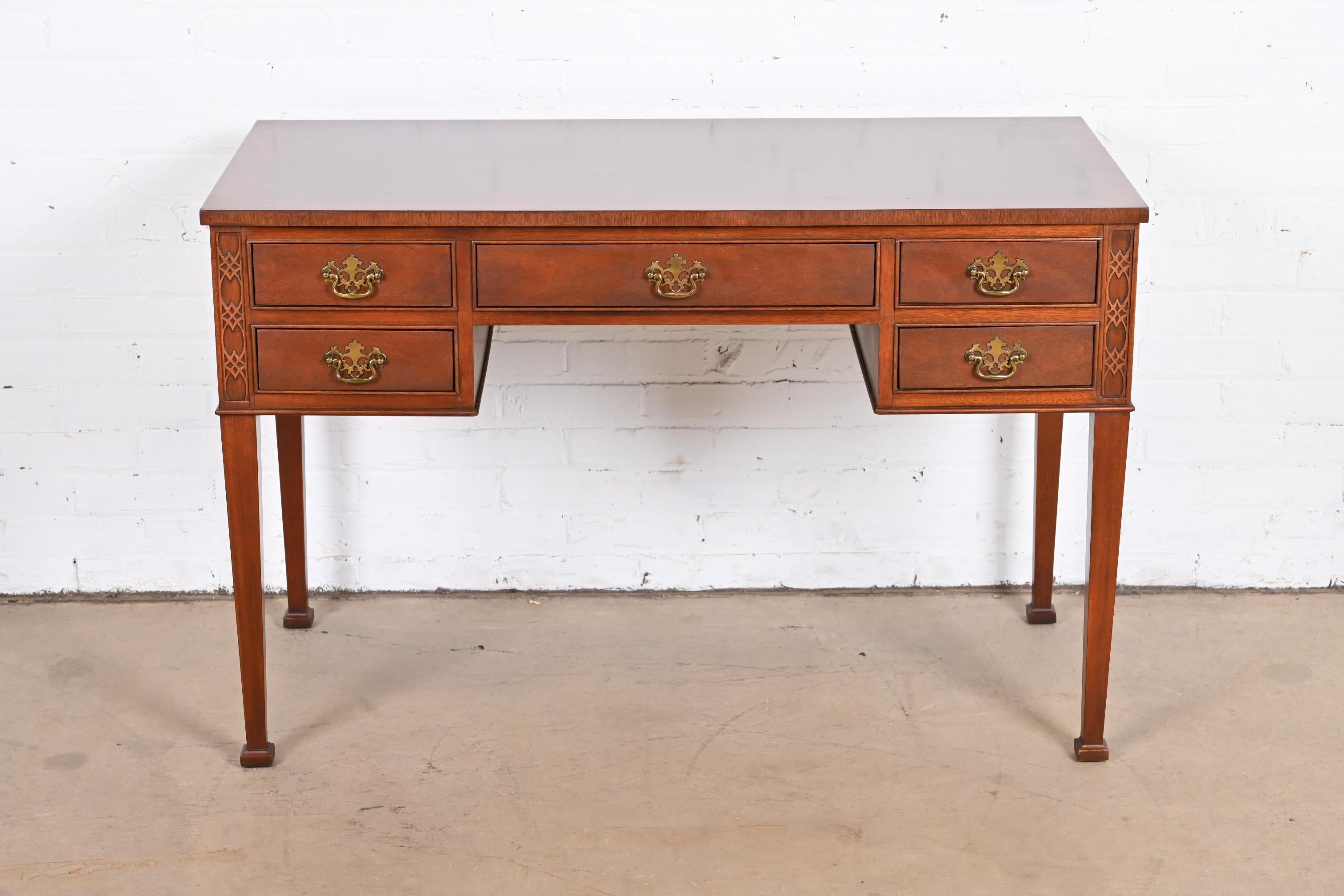 A gorgeous Georgian or Chippendale style writing desk

By Baker Furniture

USA, circa 1980s

Carved mahogany, with original brass hardware.

Measures: 45.5