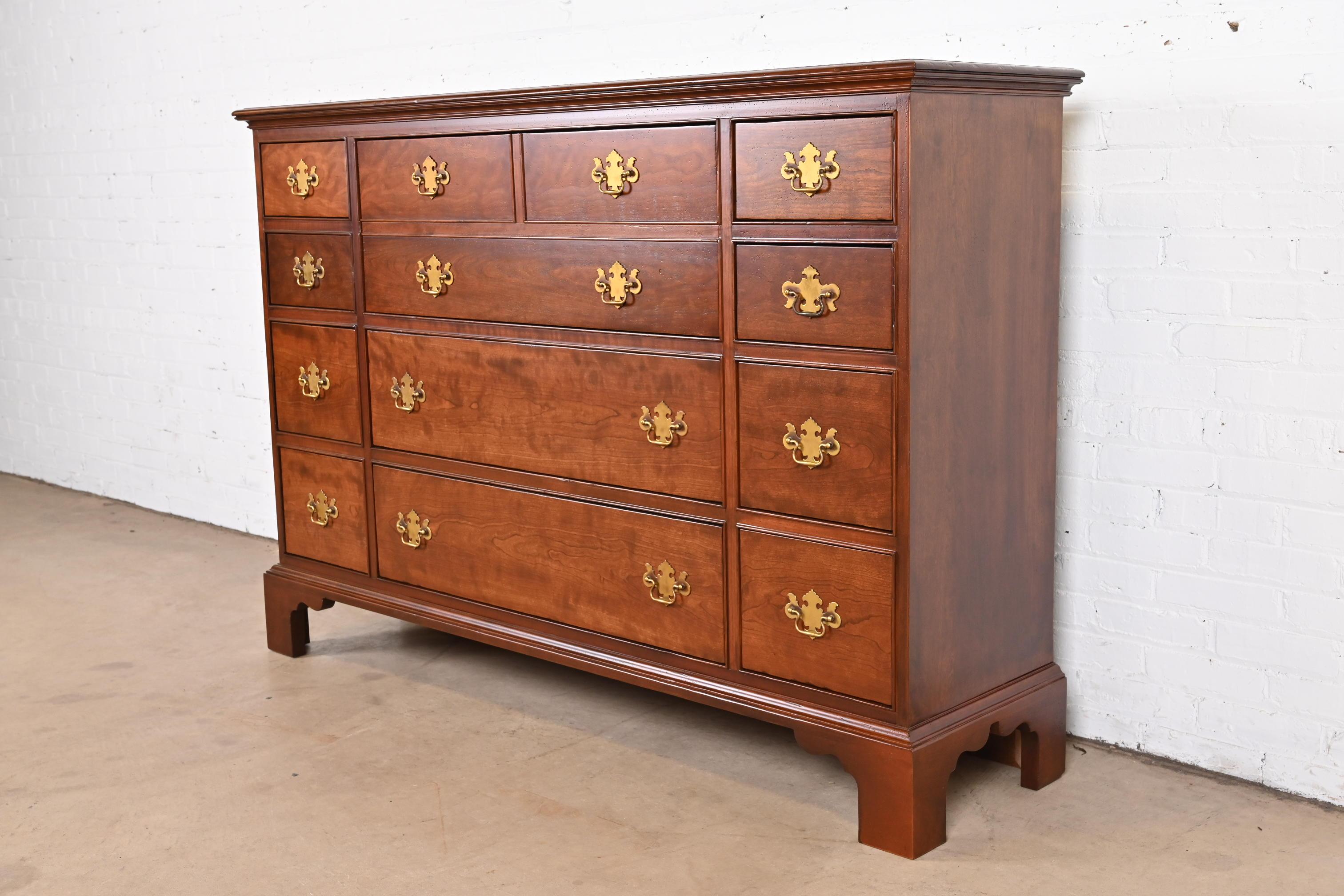 A beautiful Georgian or Chippendale style ten-drawer dresser or chest of drawers with drop front secretary desk

By Baker Furniture, 