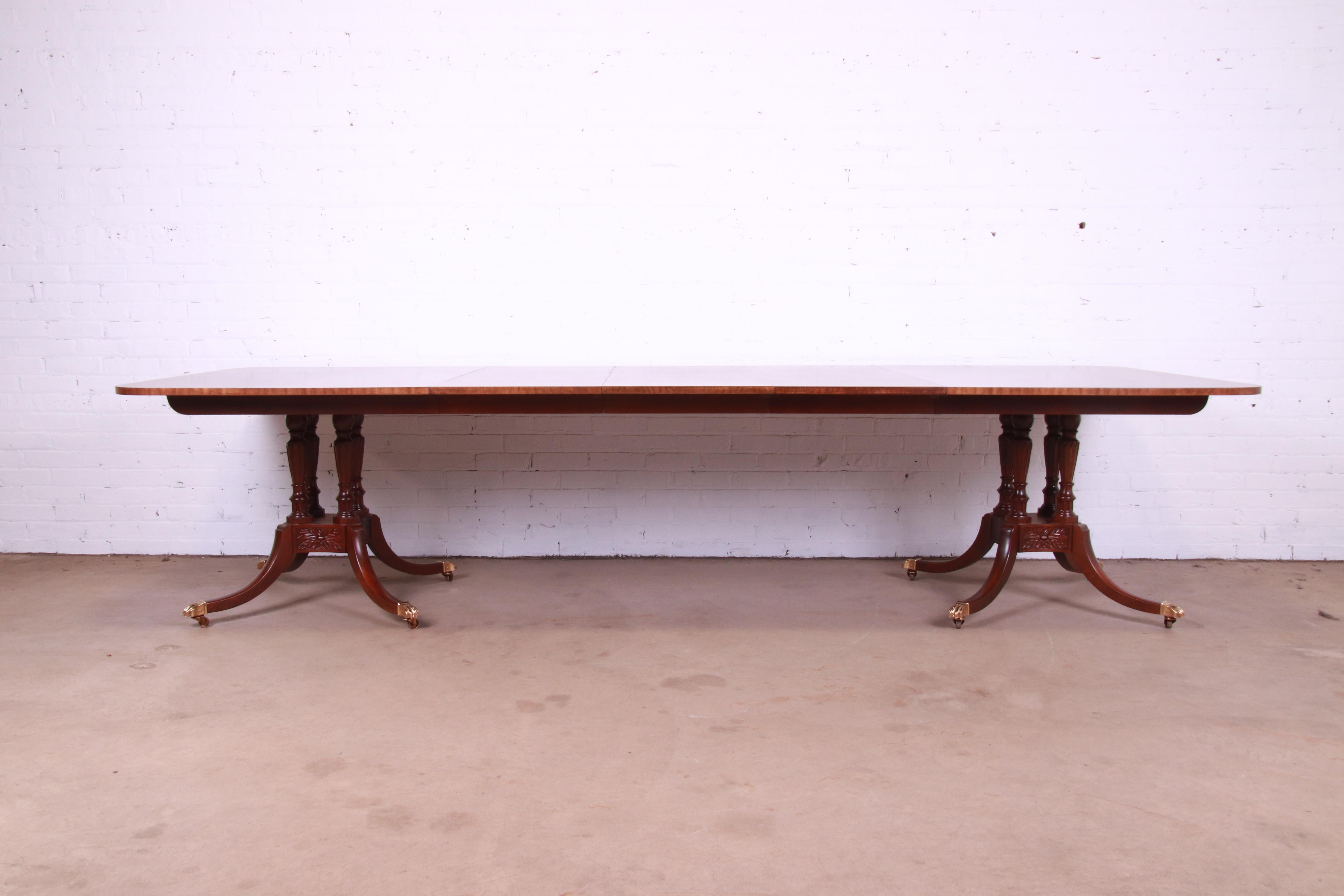 An exceptional Georgian or Sheraton style double pedestal extension dining table

By Baker Furniture, 