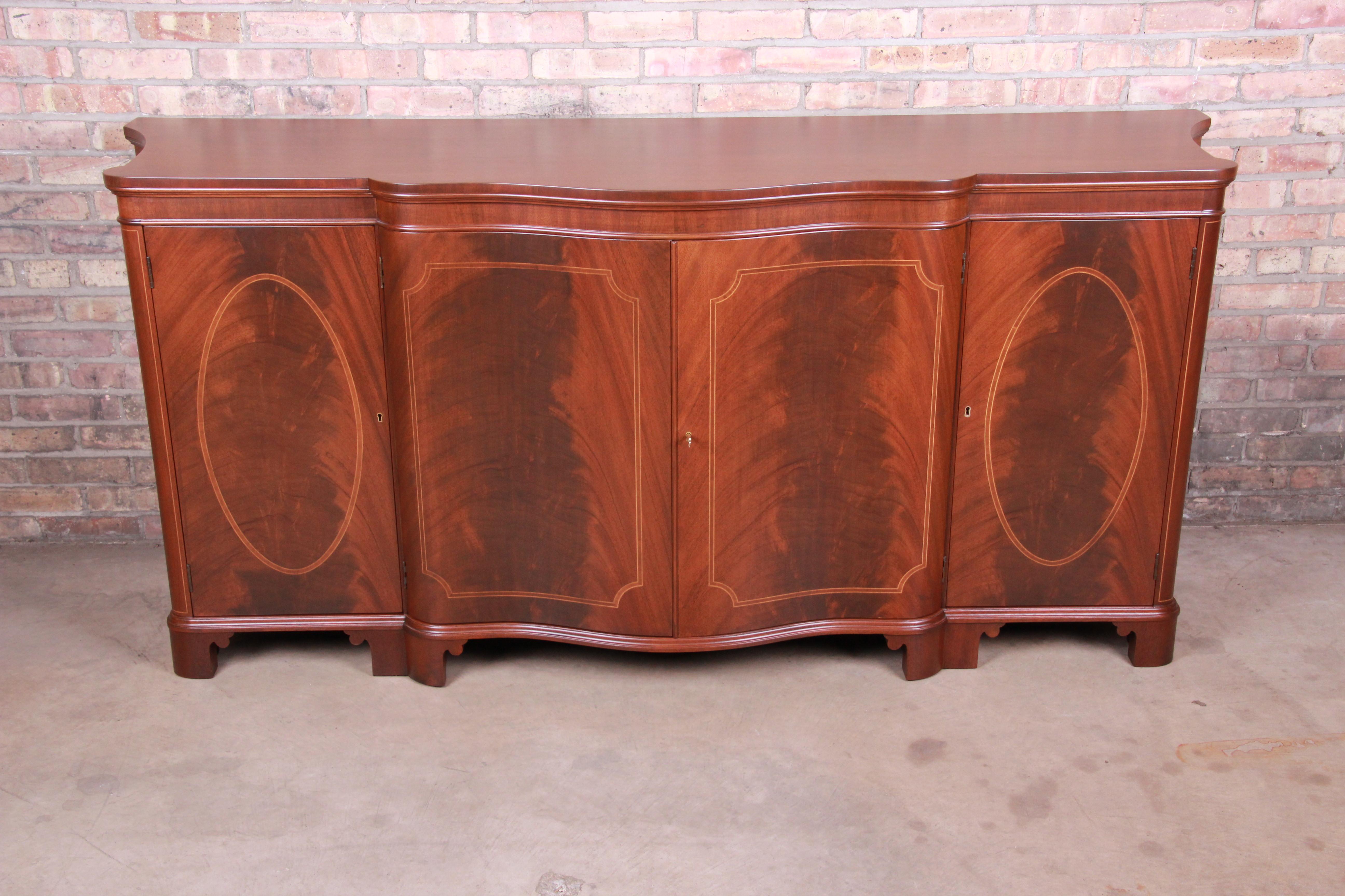 An exceptional Georgian style sideboard buffet or bar cabinet

By Baker Furniture

USA, circa 1950s

Flame mahogany, with pencil inlay. Cabinet doors lock, and original key is included.

Measures: 78