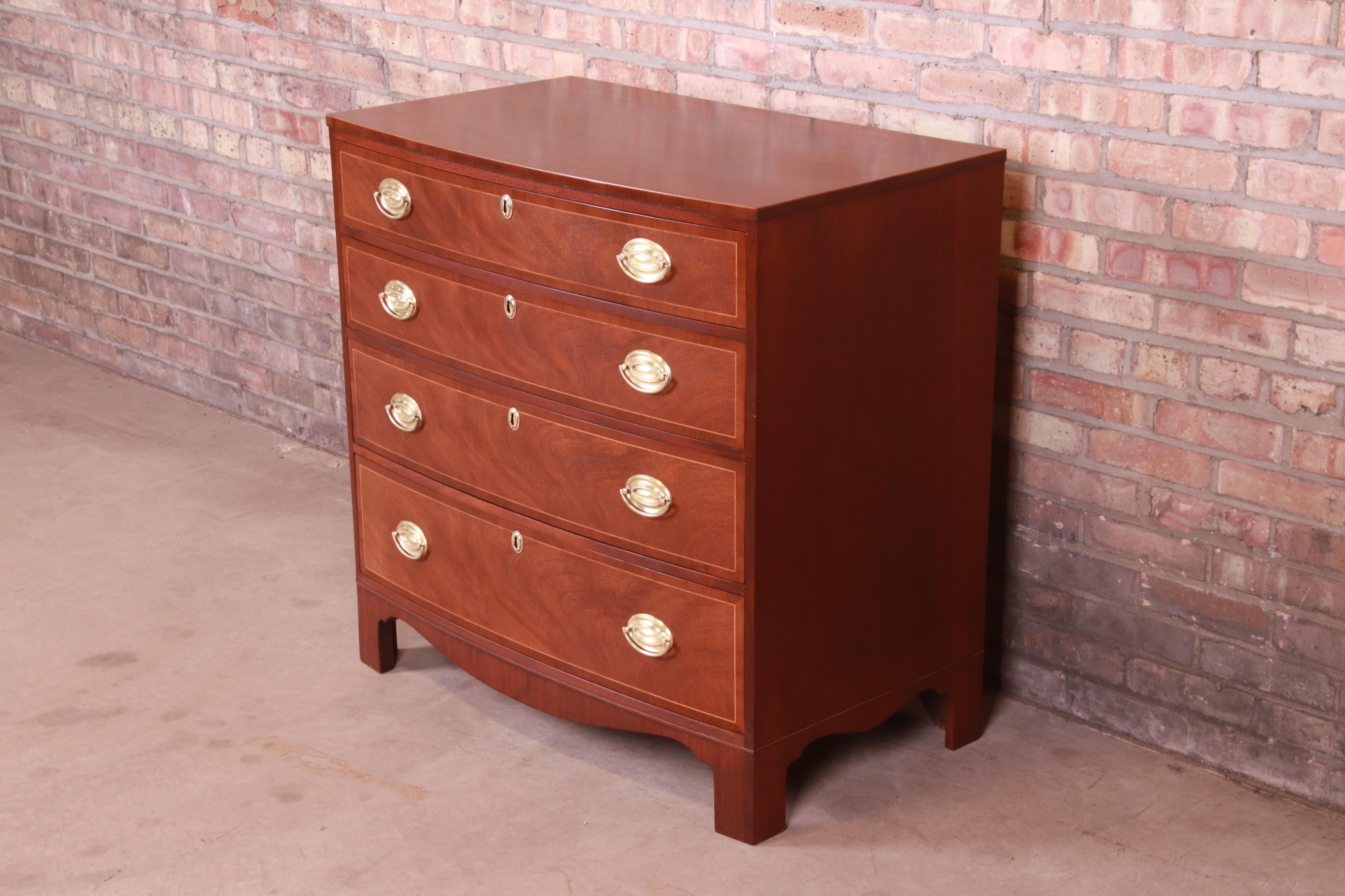 A gorgeous Georgian style four-drawer chest of drawers or commode

By Baker Furniture

USA, Circa 1980s

Mahogany, with satinwood string inlay and original brass hardware.

Measures: 35.25