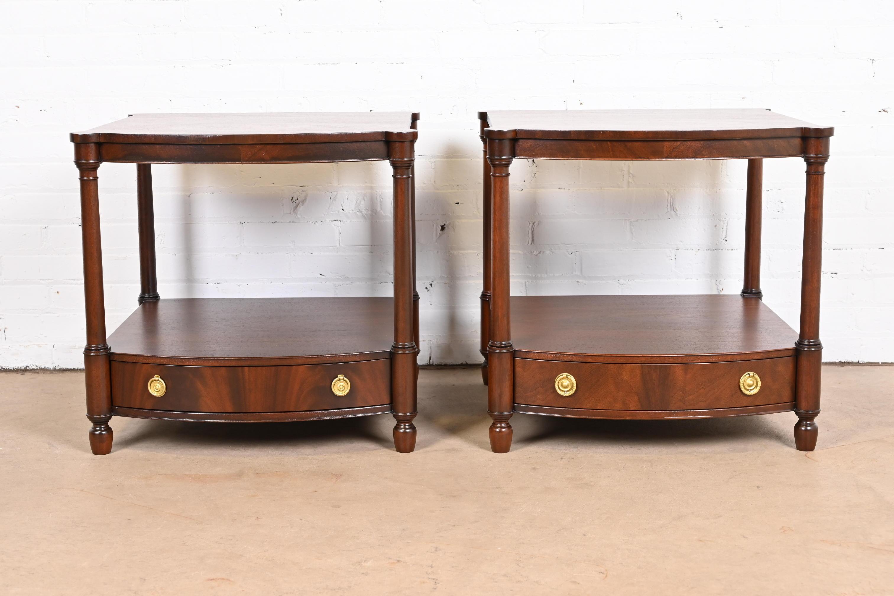 A gorgeous pair of Georgian or Chippendale style bow front nightstands or side tables

By Baker Furniture

USA, Circa 1980s

Flame mahogany, with original brass hardware.

Measures: 24