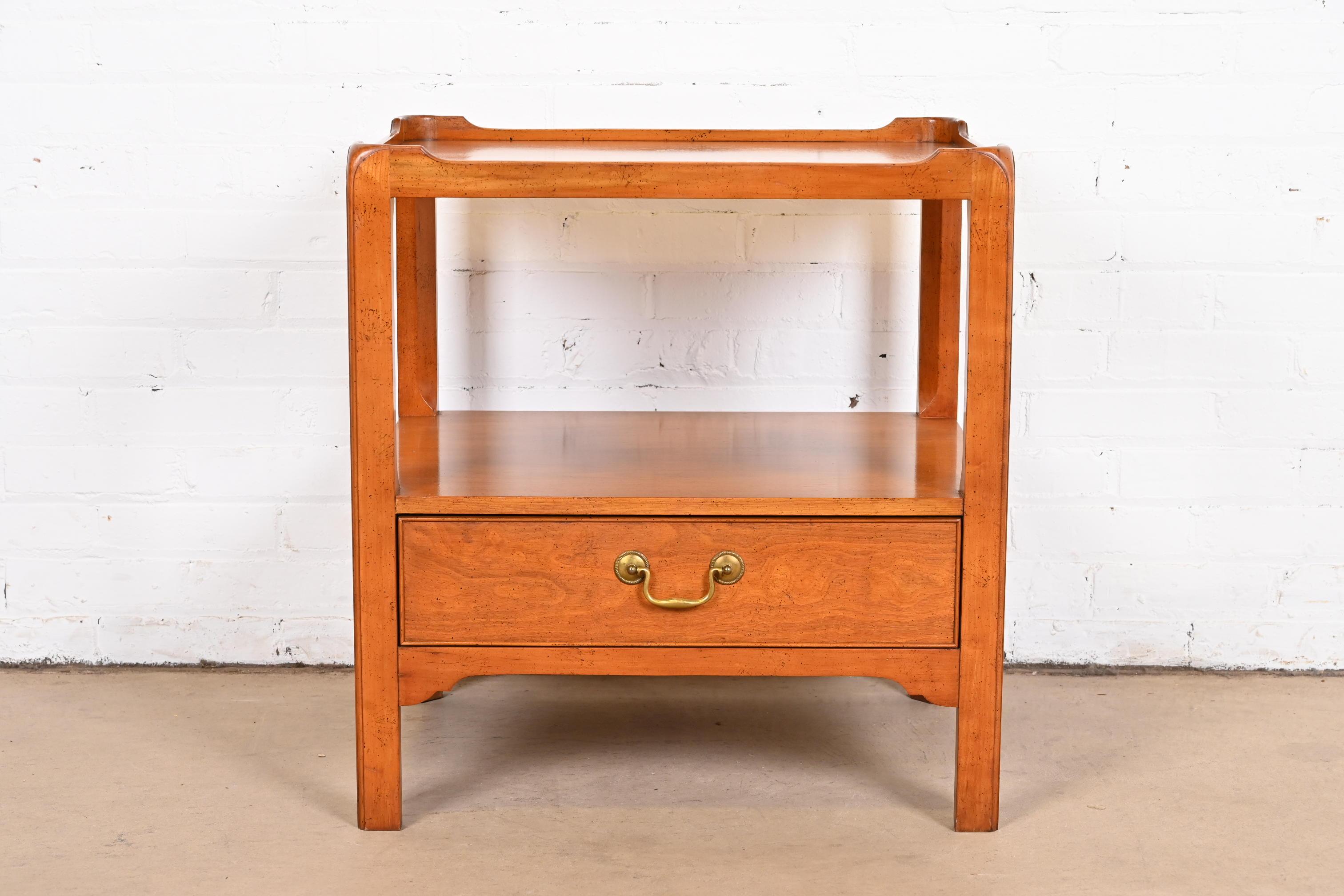 A beautiful Georgian style end table or bedside table.

By Baker Furniture

USA, circa 1980s

Carved mahogany, with original brass hardware.

Measures: 24