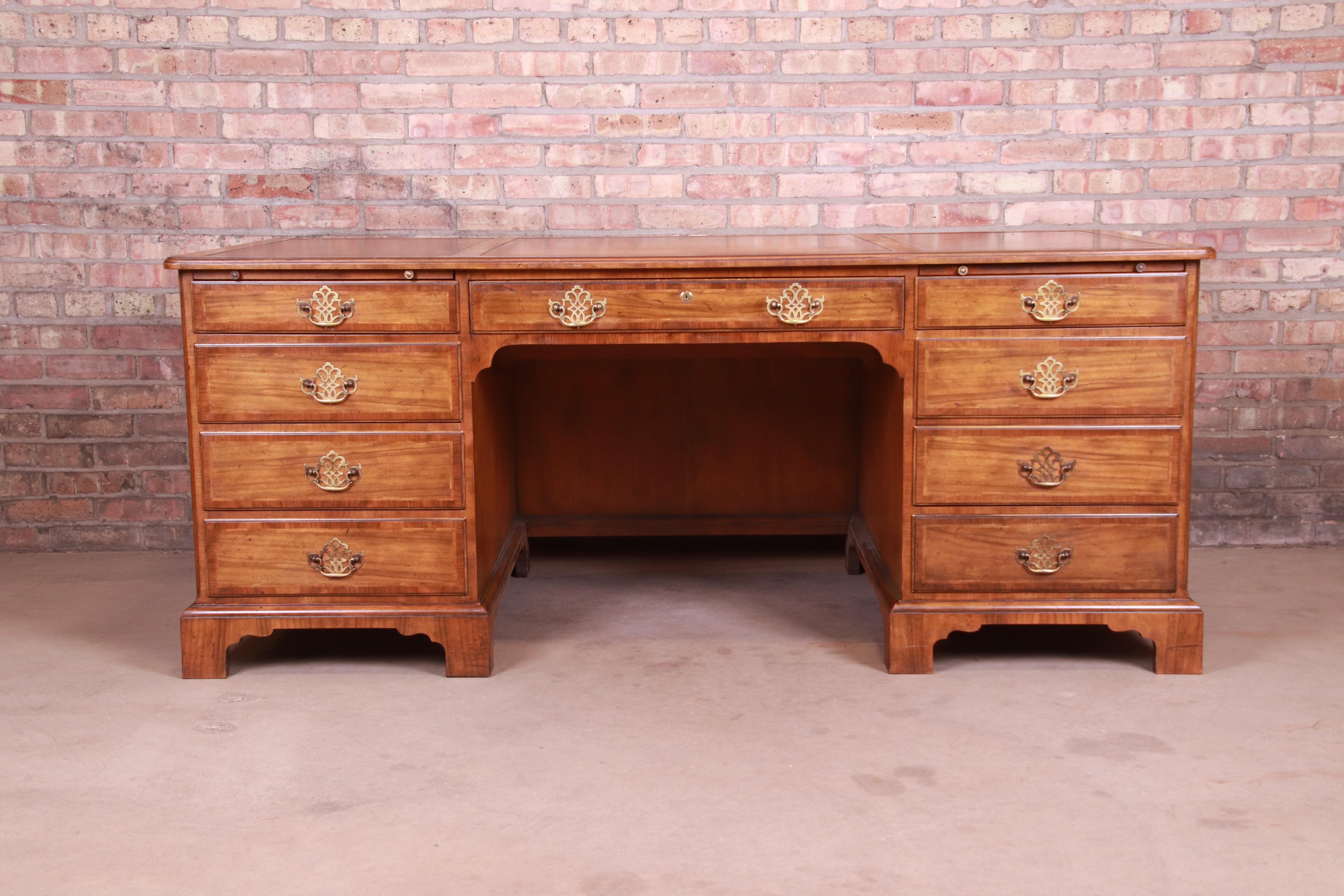 A stately Georgian or Chippendale style executive desk 

By Baker Furniture

USA, 1950s

Gorgeous burled walnut, with original brass pulls and inlaid embossed leather top.

Measures: 72