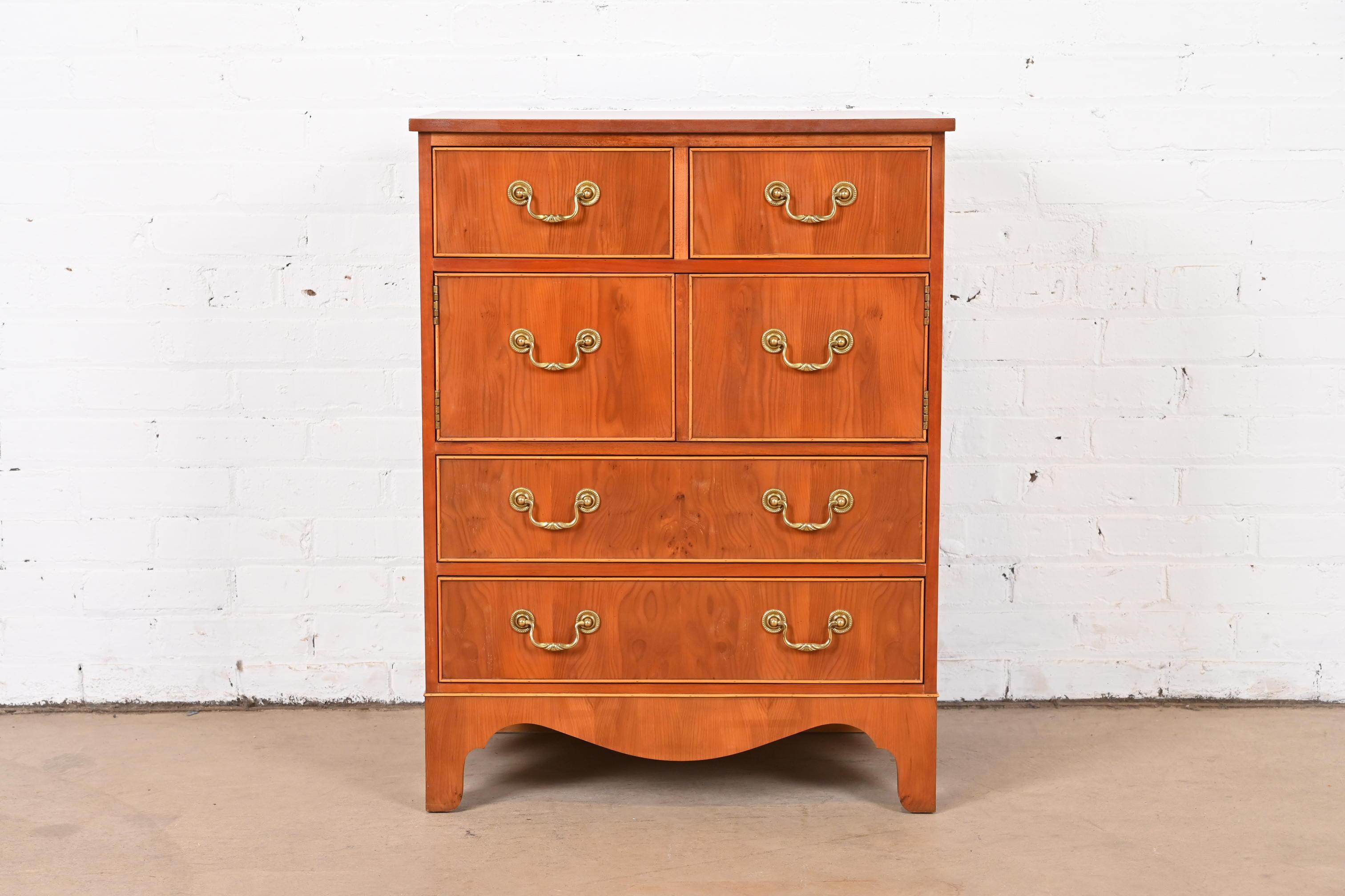 A beautiful English Georgian style four-drawer commode or chest of drawers

By Baker Furniture

USA, Circa 1980s

Gorgeous yew wood, with ebony string inlay on top, and original brass hardware.

Measures: 24.38