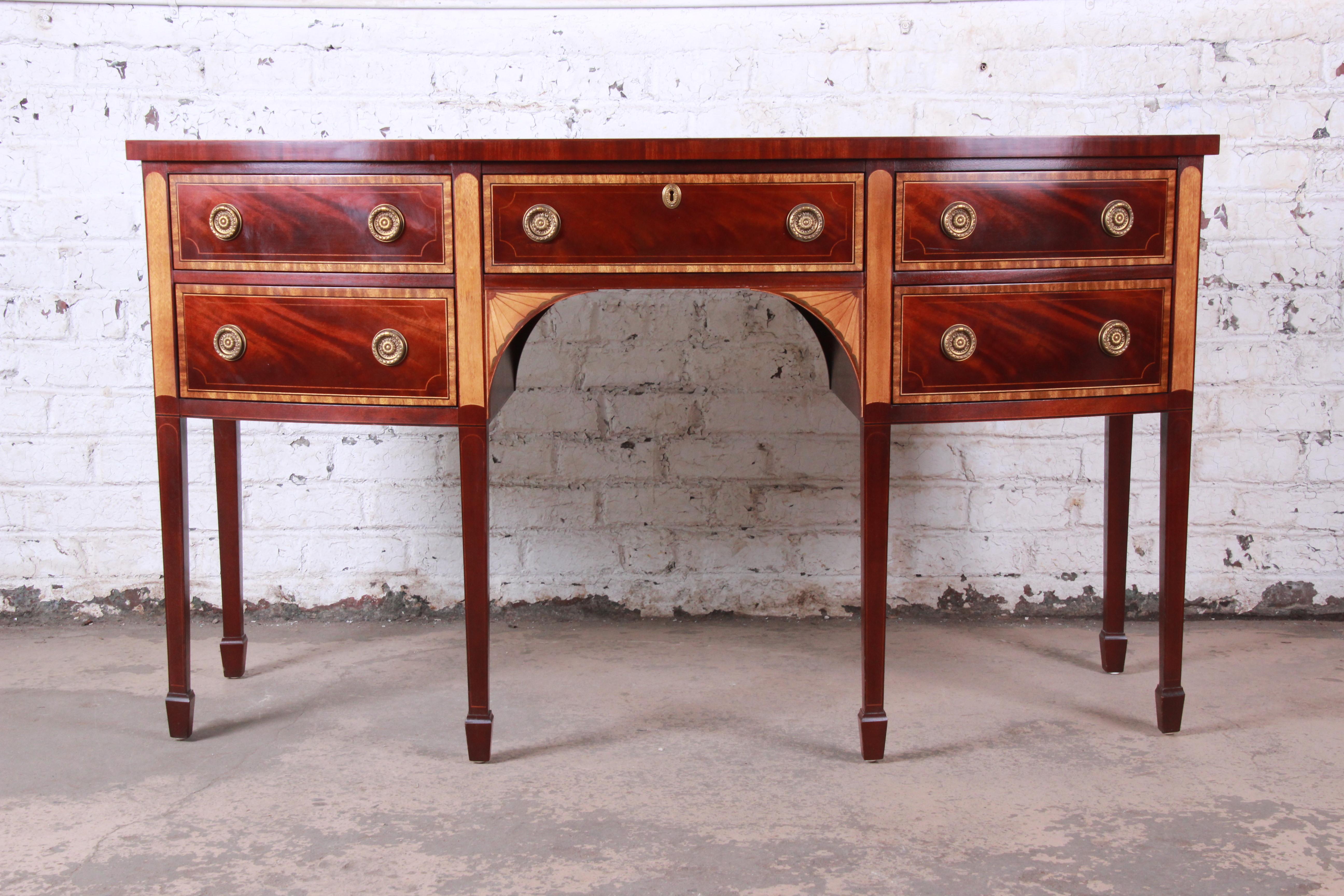 An exceptional Hepplewhite style flame mahogany and satinwood sideboard credenza or buffet server

By Baker Furniture 