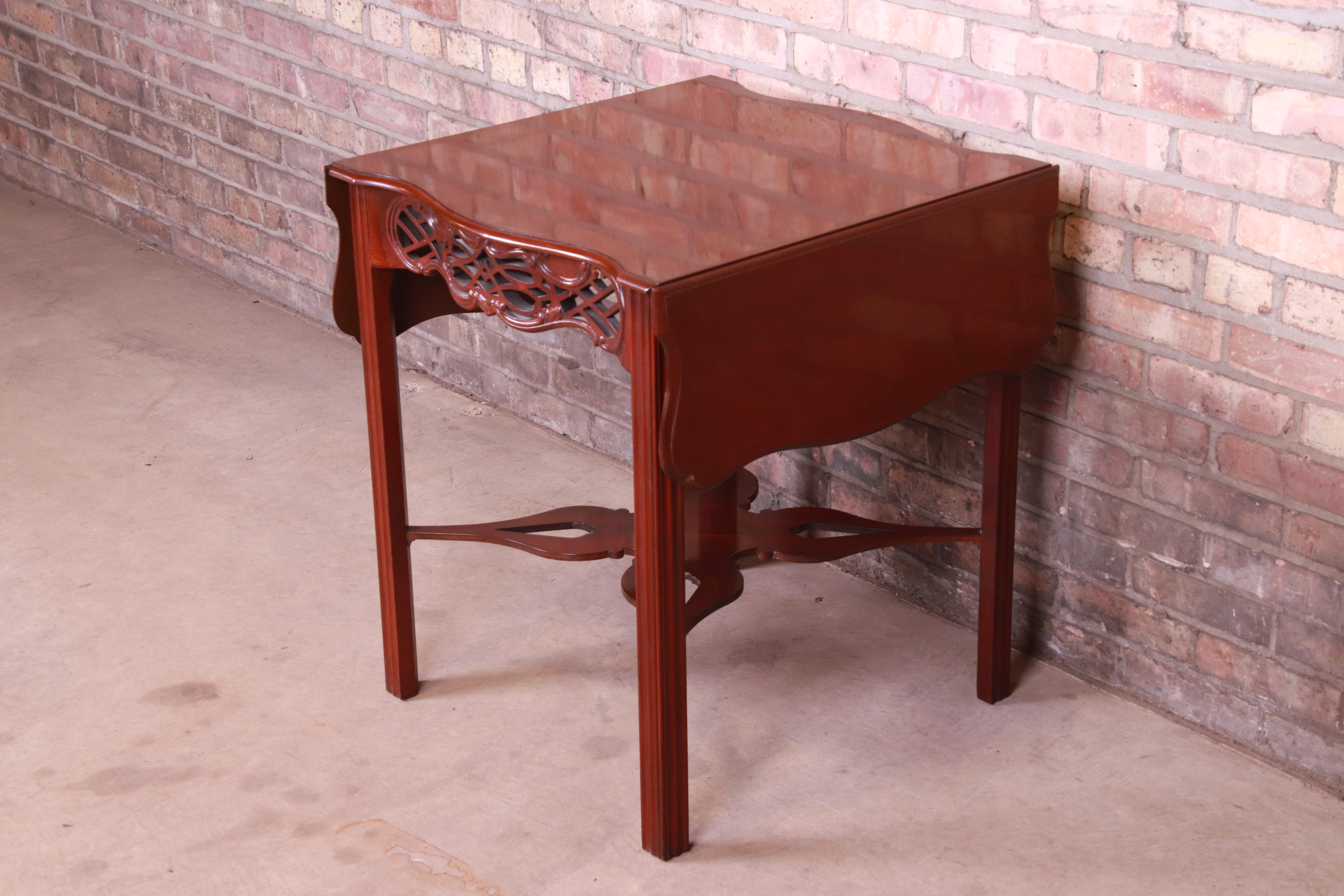 An exceptional Chippendale style carved mahogany pembroke drop-leaf side table

By Baker Furniture 