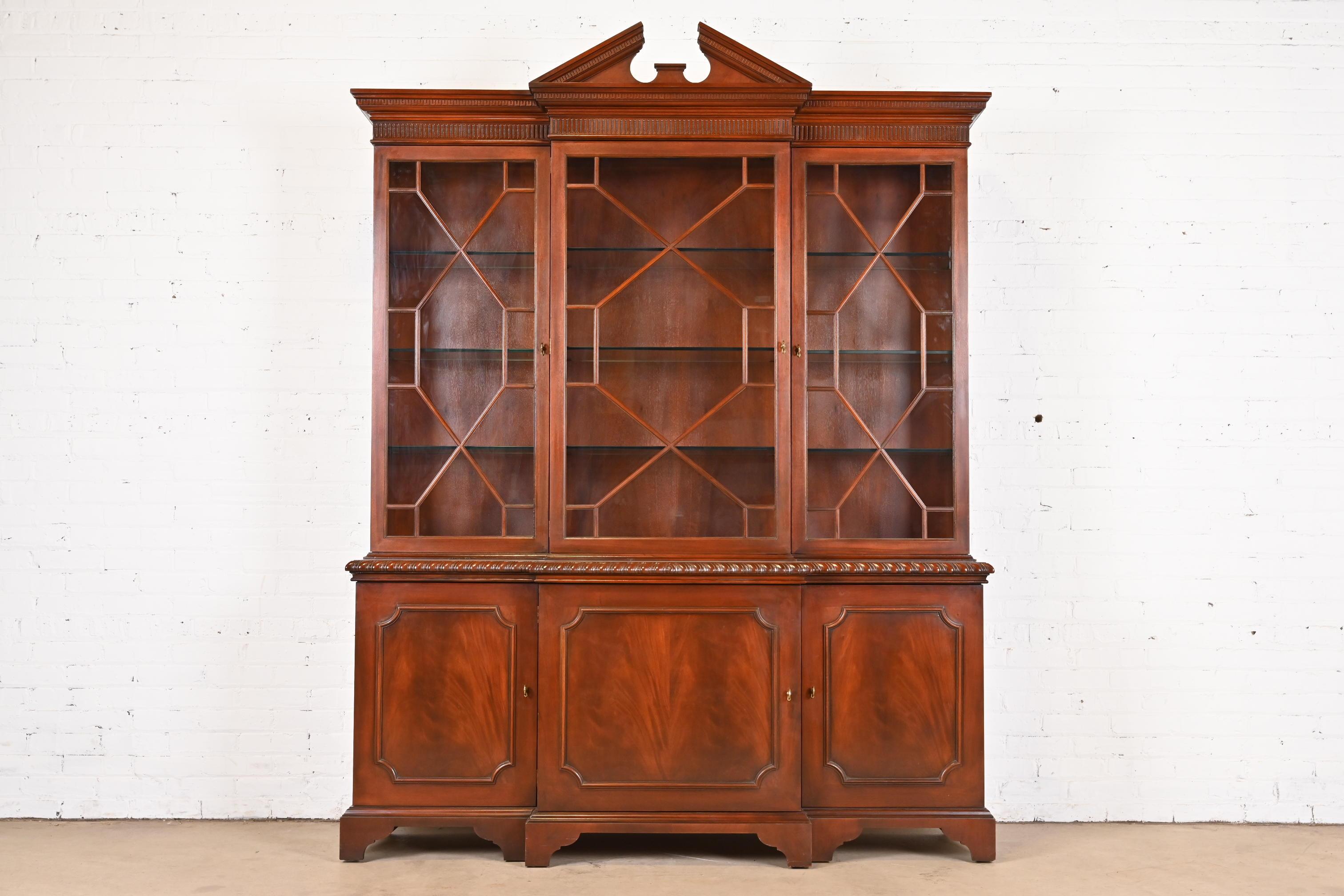 A gorgeous Georgian or Chippendale style lighted breakfront bookcase or dining cabinet

By Baker Furniture, 