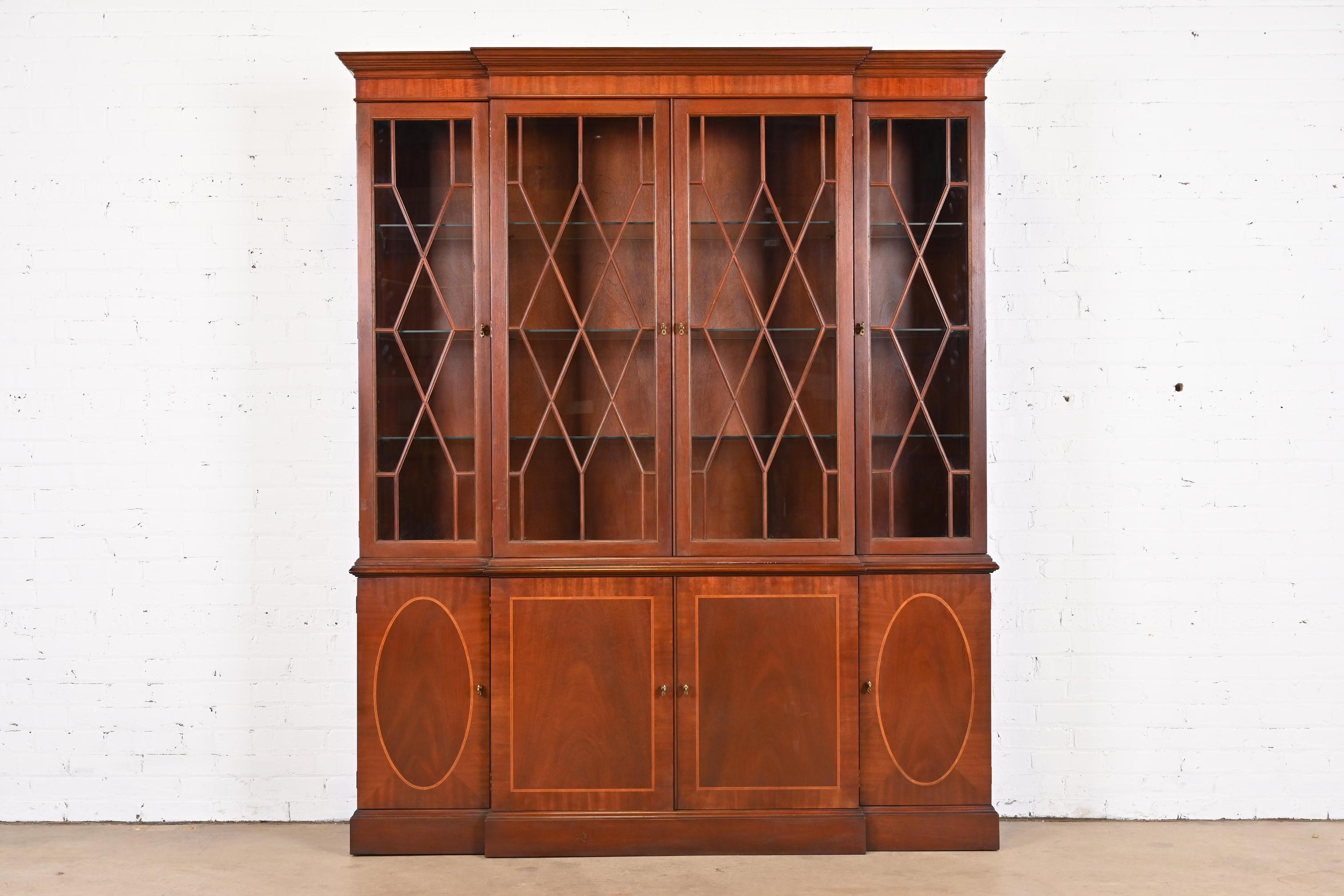 A gorgeous Georgian or Chippendale style lighted breakfront bookcase cabinet or dining cabinet

By Baker Furniture, 