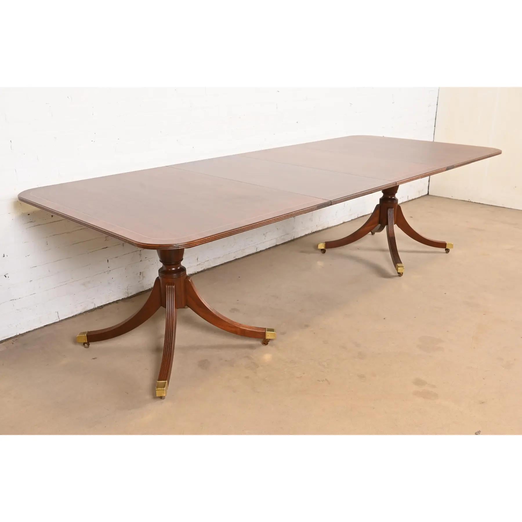 An exceptional Georgian or Regency style double pedestal extension dining table

By Baker Furniture, 